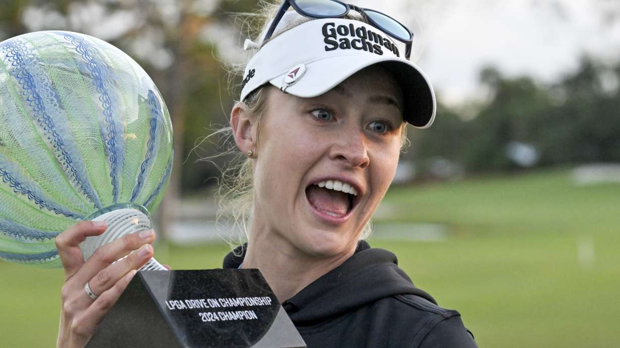 Nelly Korda holds the championship trophy after winning the LPGA Drive On Championship golf tournament at Bradenton Country Club, Sunday, Jan. 28, 2024, in Bradenton, Fla.