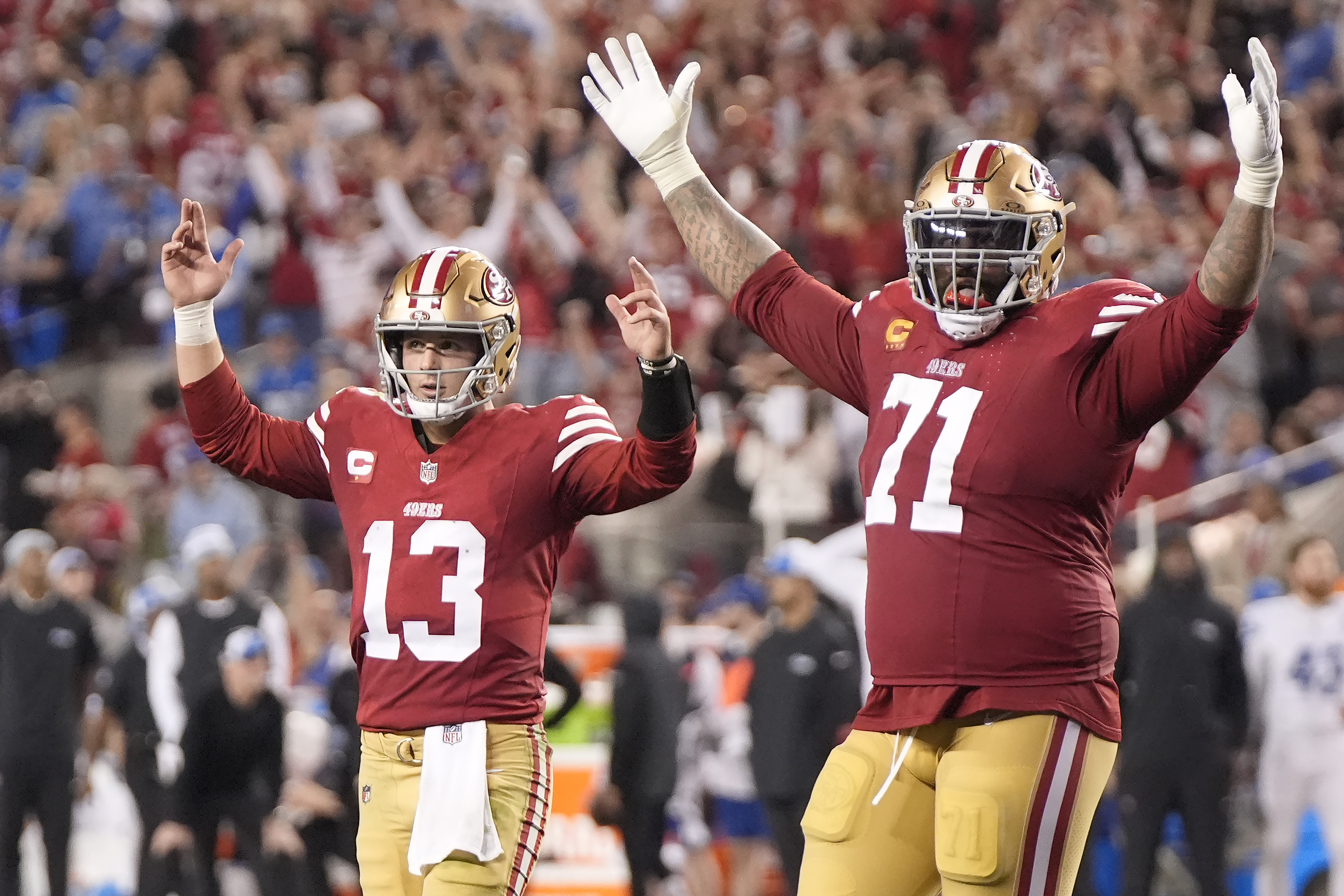 San Francisco 49ers quarterback Brock Purdy (13) and offensive tackle Trent Williams (71) celebrate after a touchdown run by Elijah Mitchell during the second half of the NFC Championship NFL football game against the Detroit Lions in Santa Clara, Calif., Sunday, Jan. 28, 2024. 