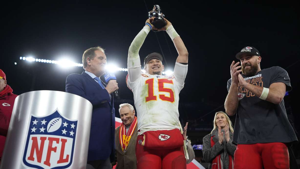 Kansas City Chiefs quarterback Patrick Mahomes (15) holds up the Lamar Hunt Trophy next to Kansas City Chiefs tight end Travis Kelce (87) after the AFC Championship NFL football game against the Baltimore Ravens, Sunday, Jan. 28, 2024, in Baltimore. The Chiefs won 17-10.