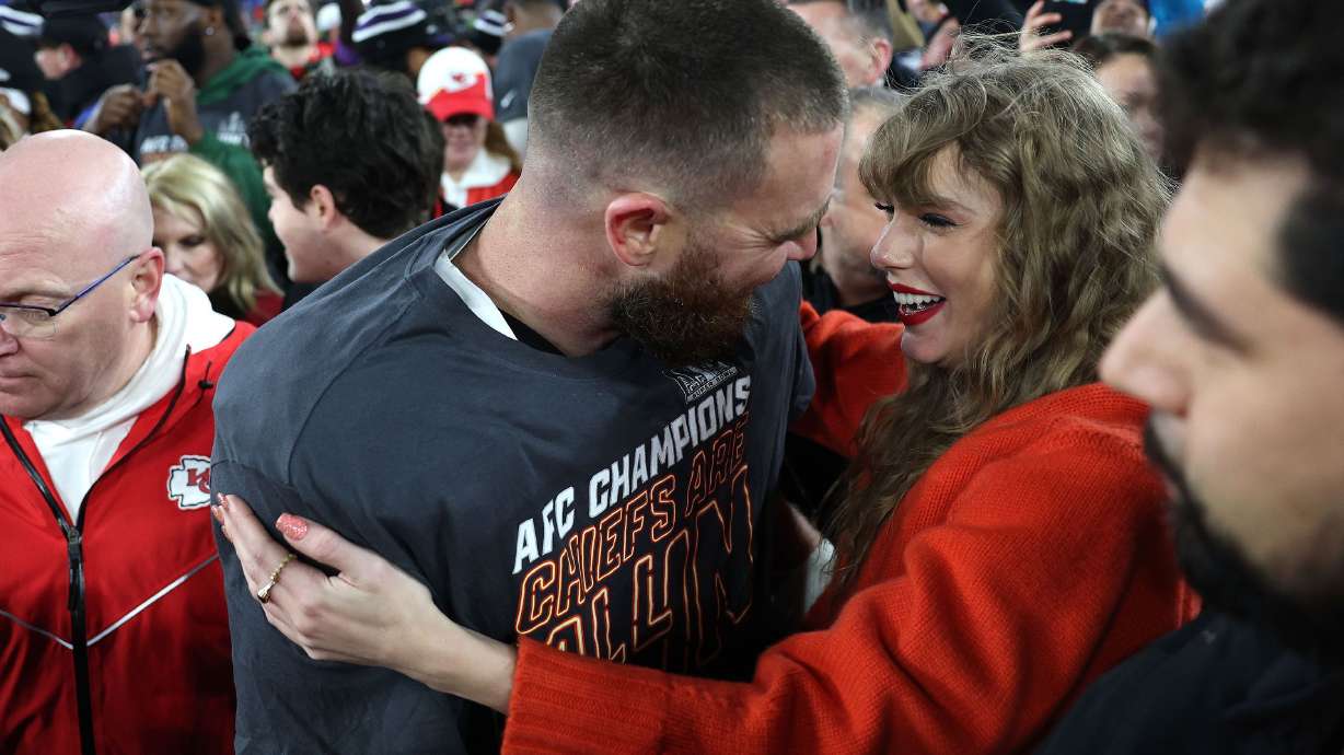 Travis Kelce and Taylor Swift celebrate on the field in Baltimore Sunday, as the Chiefs advance to the Super Bowl.