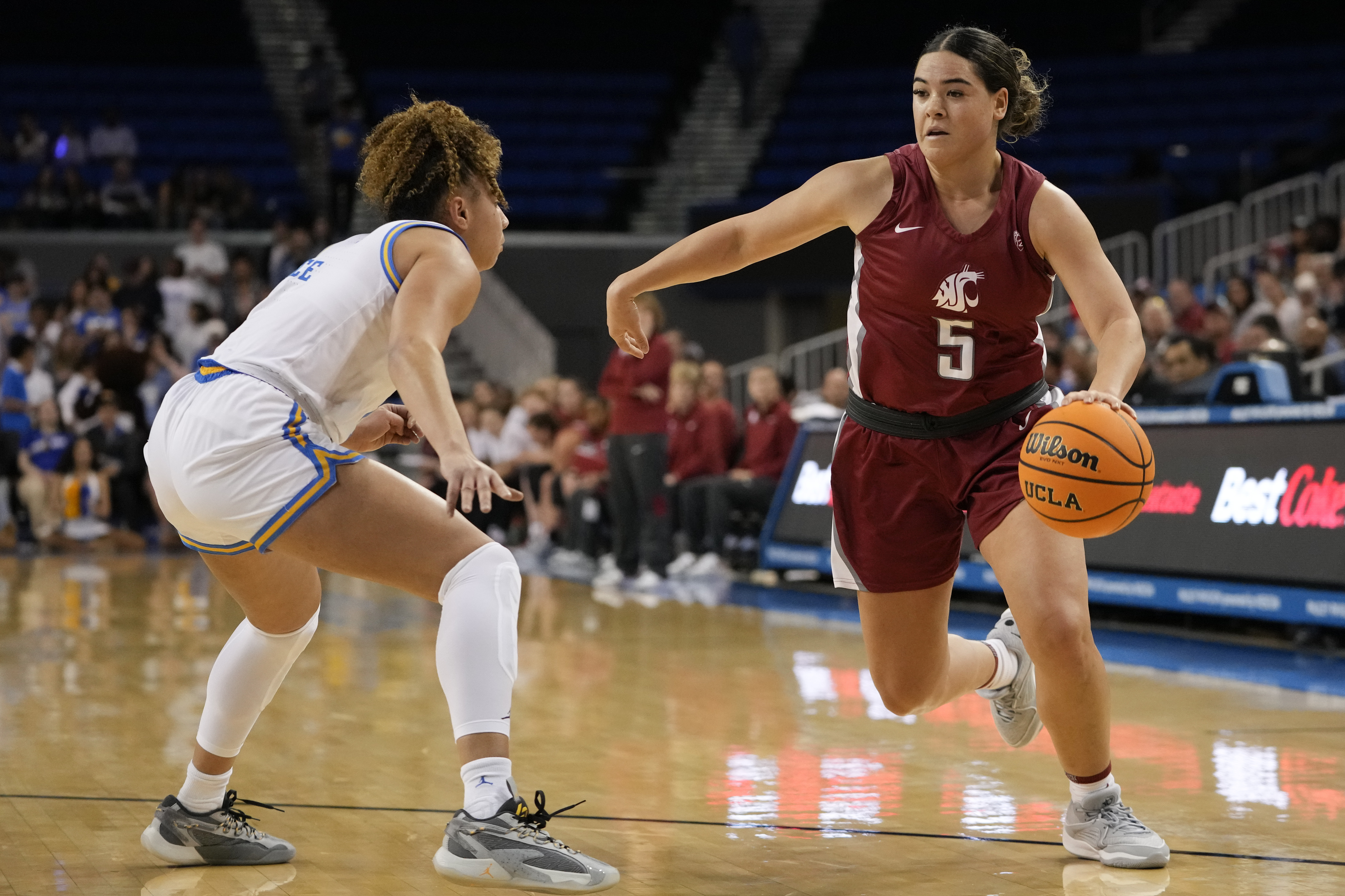 Washington State guard Charlisse Leger-Walker, right, drives against UCLA guard Kiki Rice, left, during the first half of an NCAA college basketball game, Sunday, Jan. 28, 2024, in Los Angeles.