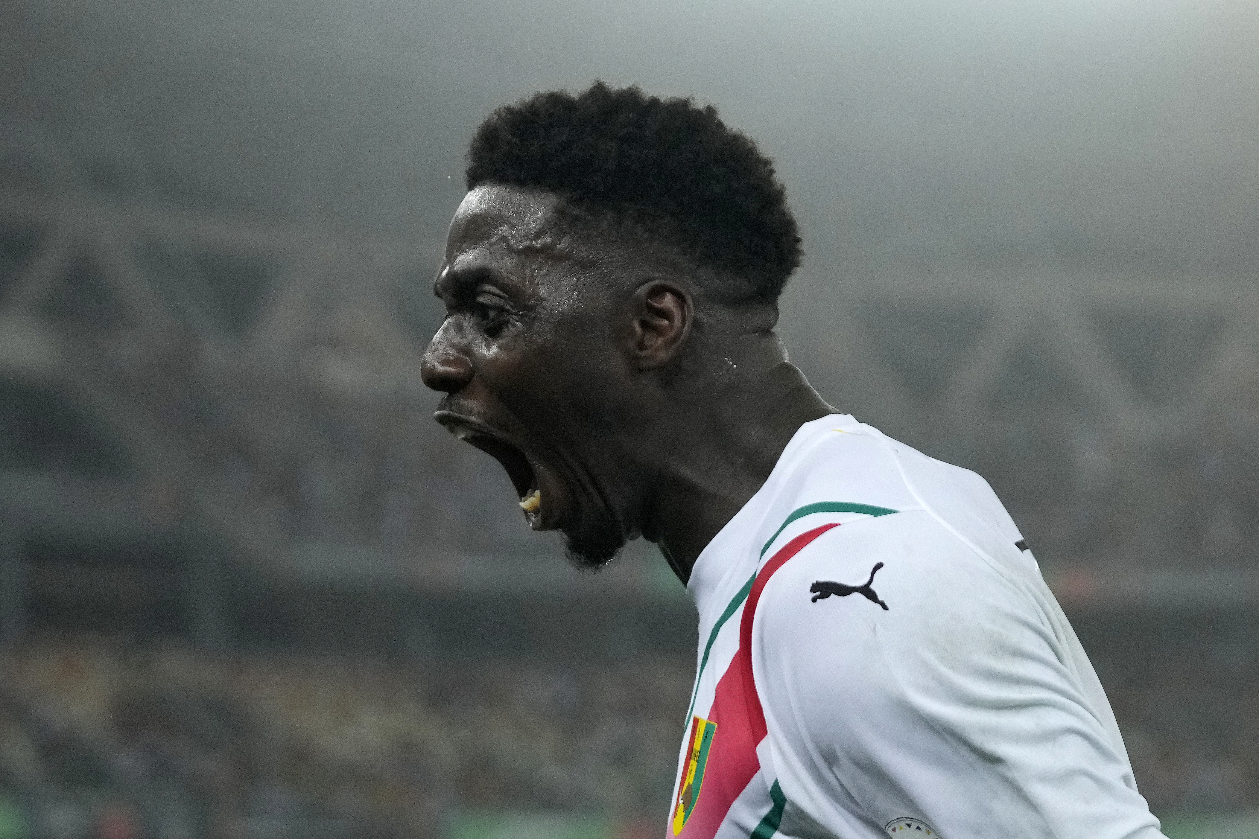 Guinea's Mohamed Bayo celebrates celebrate after scoring his side's goal during the African Cup of Nations Round of 16 soccer match between Equatorial Guinea and Guinea, at the Olympic Stadium of Ebimpe in Abidjan, Ivory Coast, Sunday, Jan. 28, 2024. 2024.