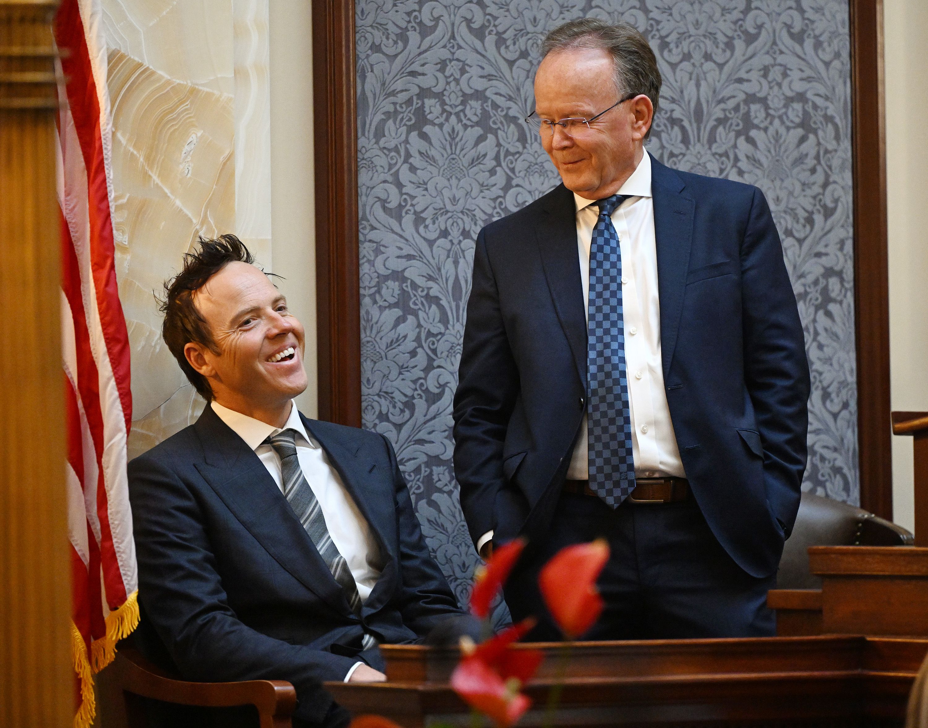 Utah Jazz owner Ryan Smith talks with Senate President Stuart Adams, R-Layton, as the SJR12 resolution on bringing an NHL hockey franchise to Utah is voted on at the Capitol in Salt Lake City on Monday.