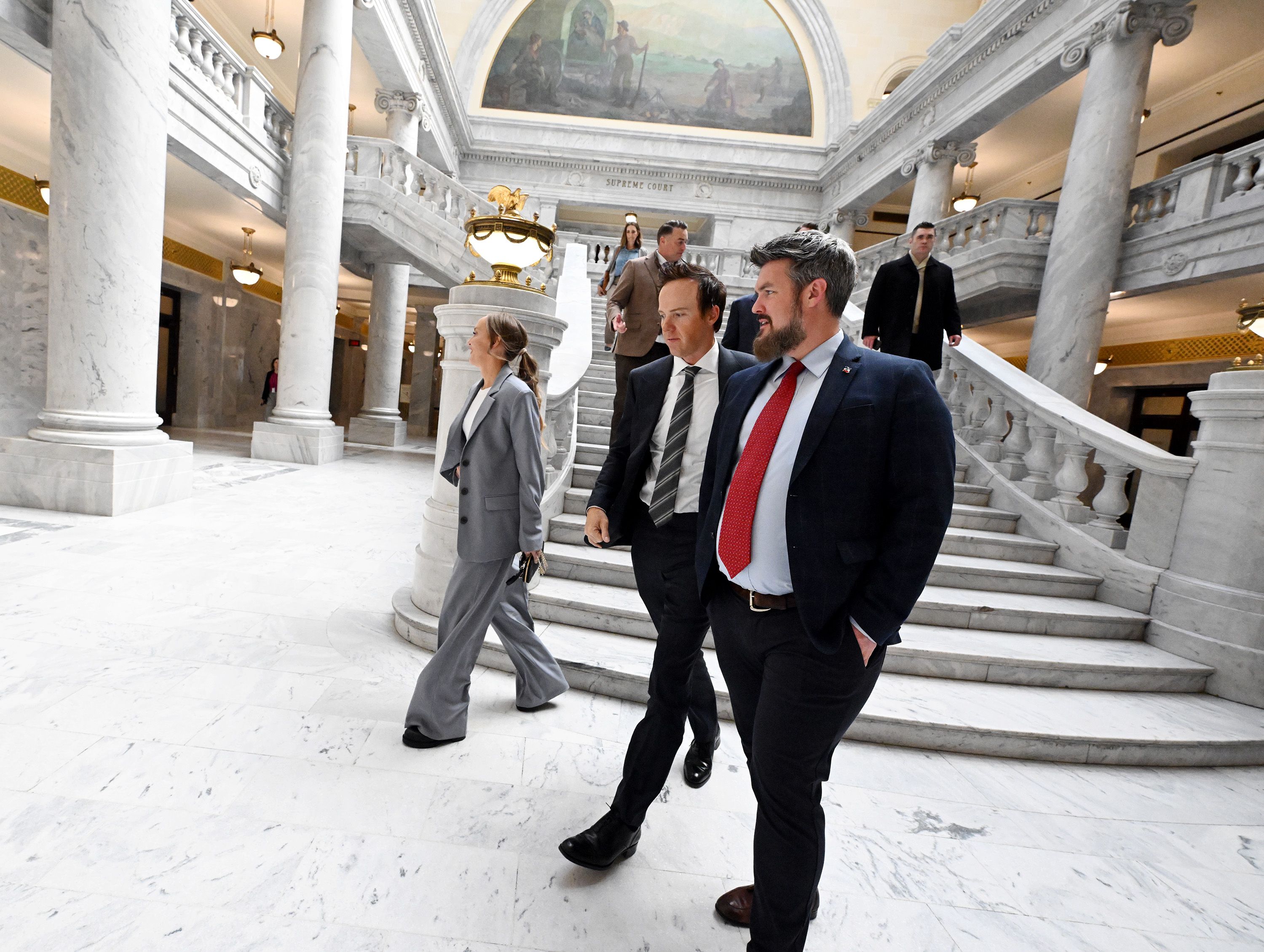 Utah Jazz owner Ryan Smith, center, and his wife Ashley Smith, left, exit the Capitol with Mike Maughan after attending the Senate as as the SJR12 resolution on bringing an NHL hockey franchise to Utah was voted on at the Capitol in Salt Lake City on Monday.