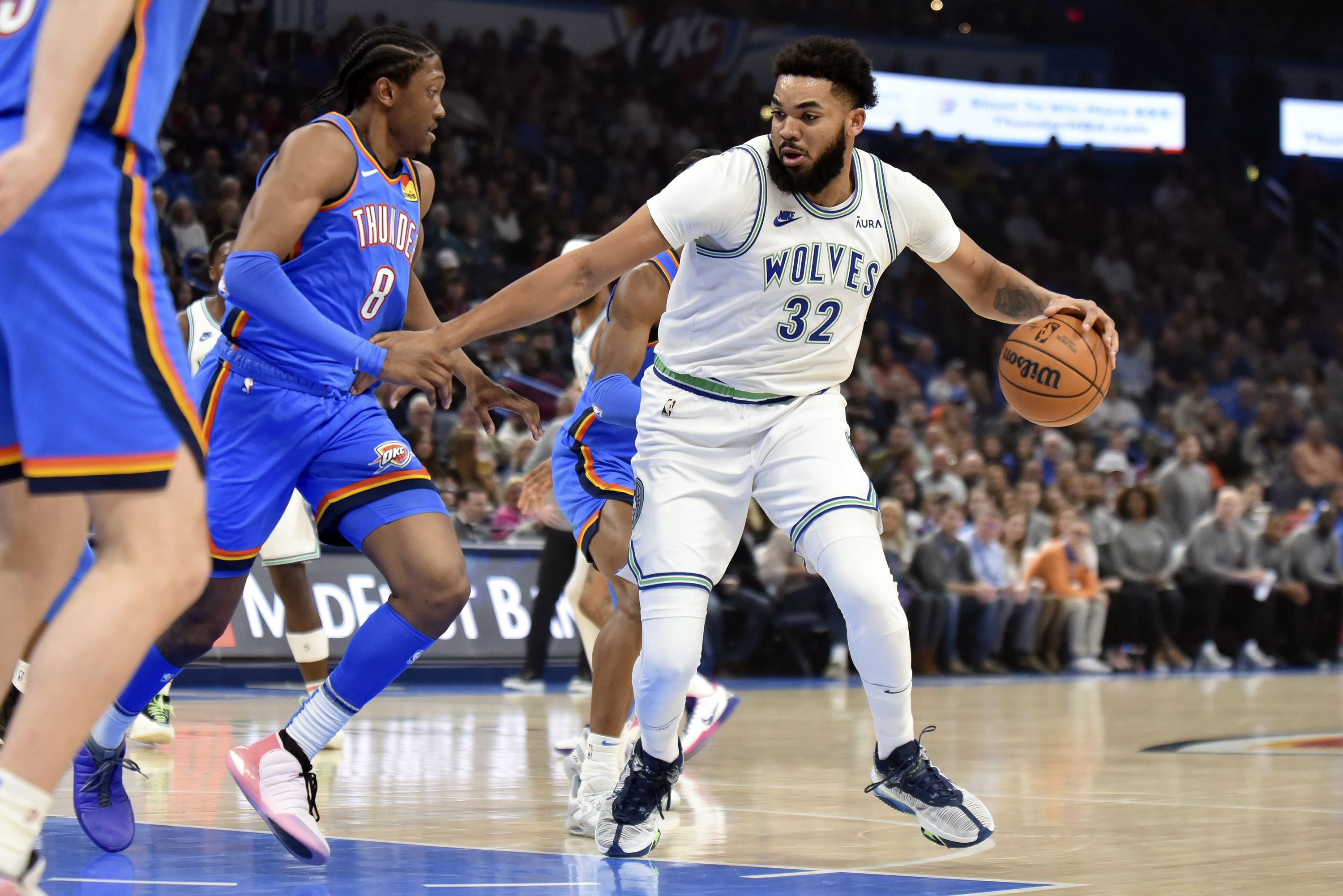 Minnesota Timberwolves center Karl-Anthony Towns (32) tries to push past Oklahoma City Thunder forward Jalen Williams (8) in the first half of an NBA basketball game, Monday, Jan. 29, 2024, in Oklahoma City. 