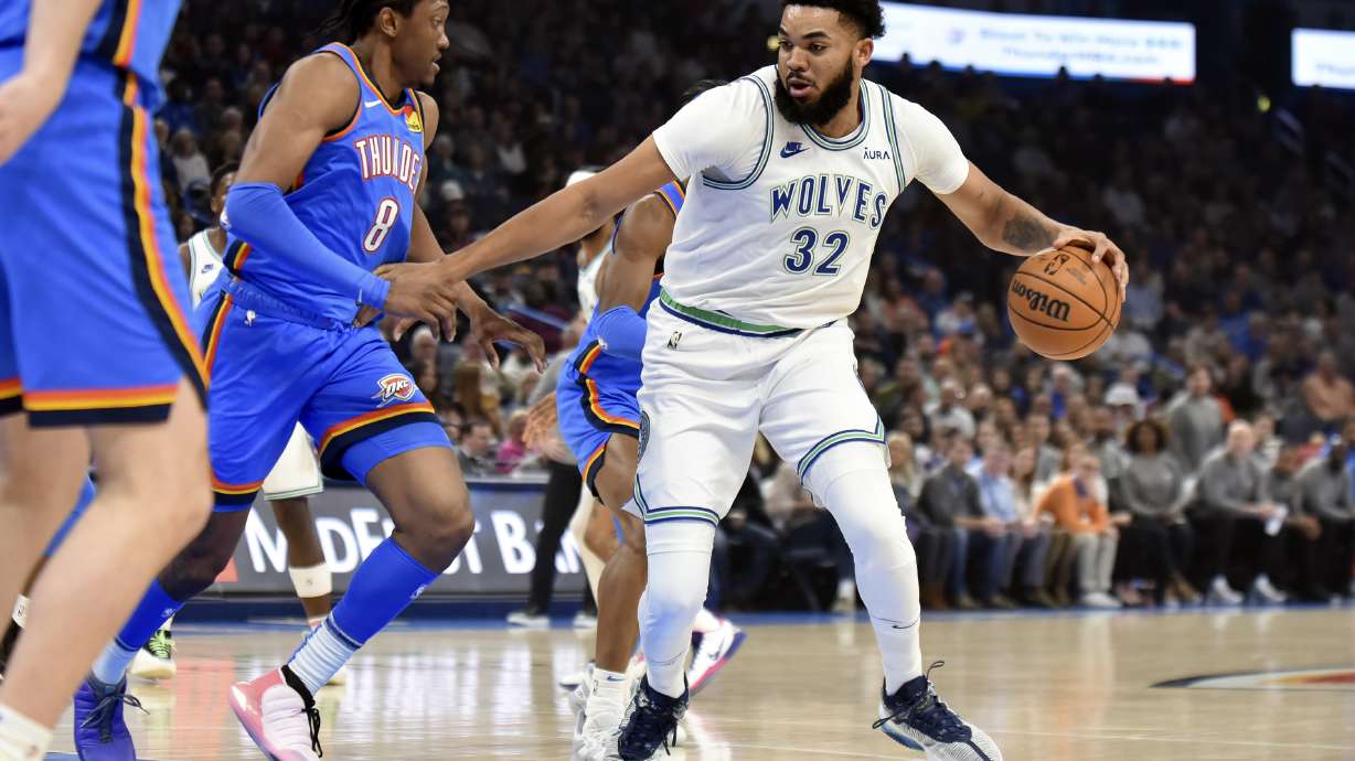 Minnesota Timberwolves center Karl-Anthony Towns (32) tries to push past Oklahoma City Thunder forward Jalen Williams (8) in the first half of an NBA basketball game, Monday, Jan. 29, 2024, in Oklahoma City.