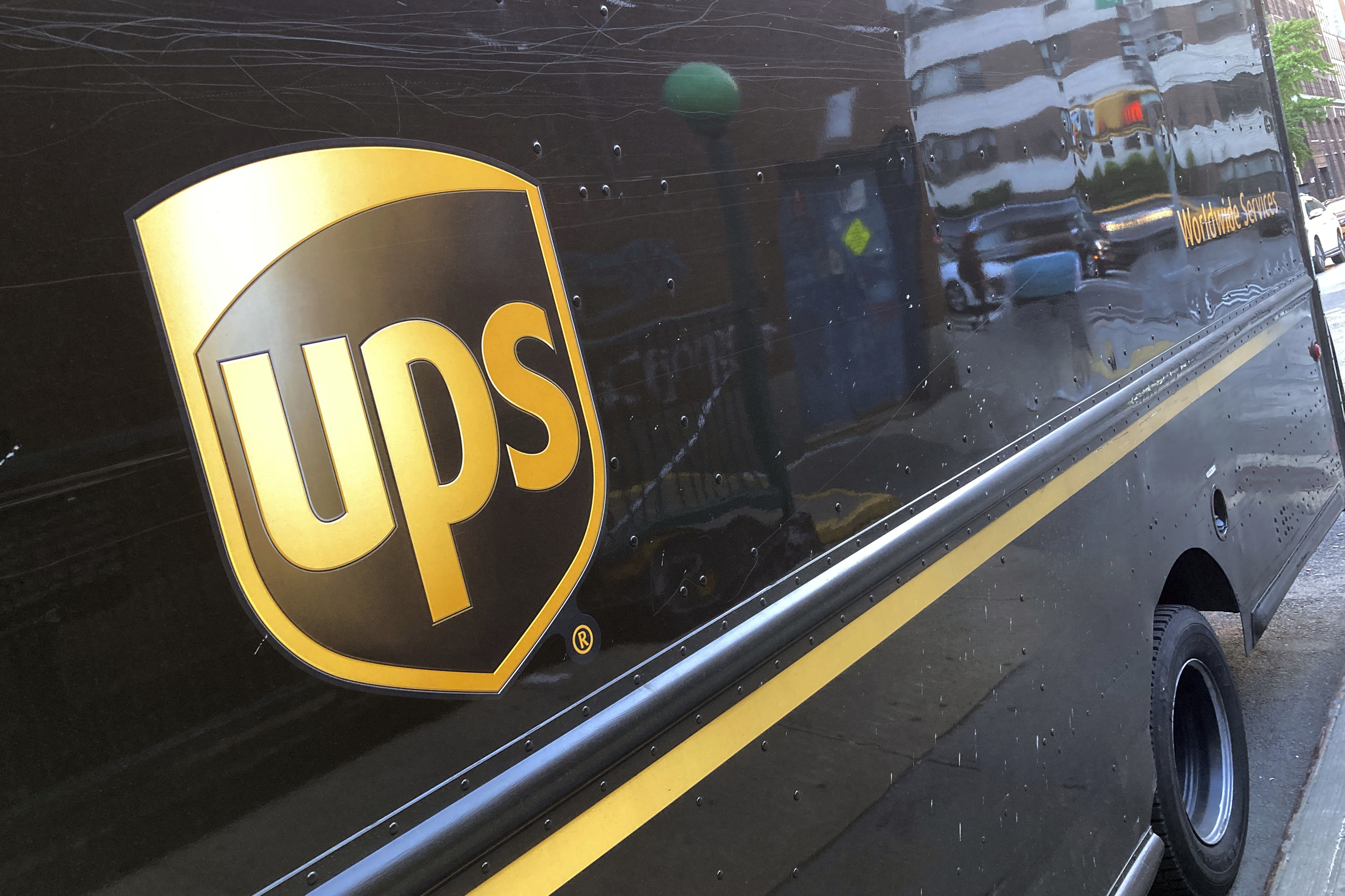 Shares of UPS fell before the market opened on Tuesday as the package delivery company gave a weaker-than-expected full-year revenue forecast and announced it will cut 12,000 jobs.