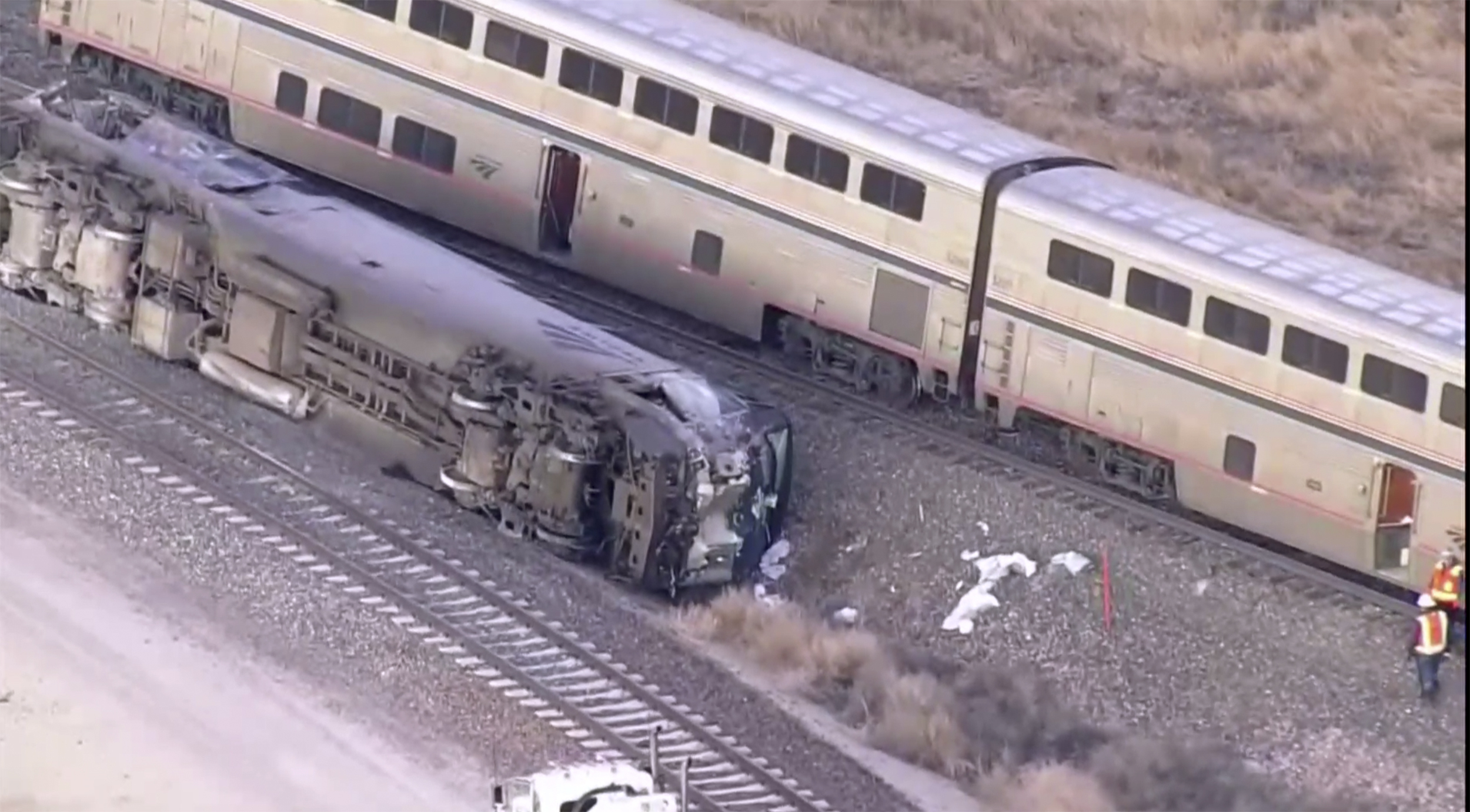 Emergency responders look over an Amtrak train derailment on Tuesday near Keenesburg, Colo.