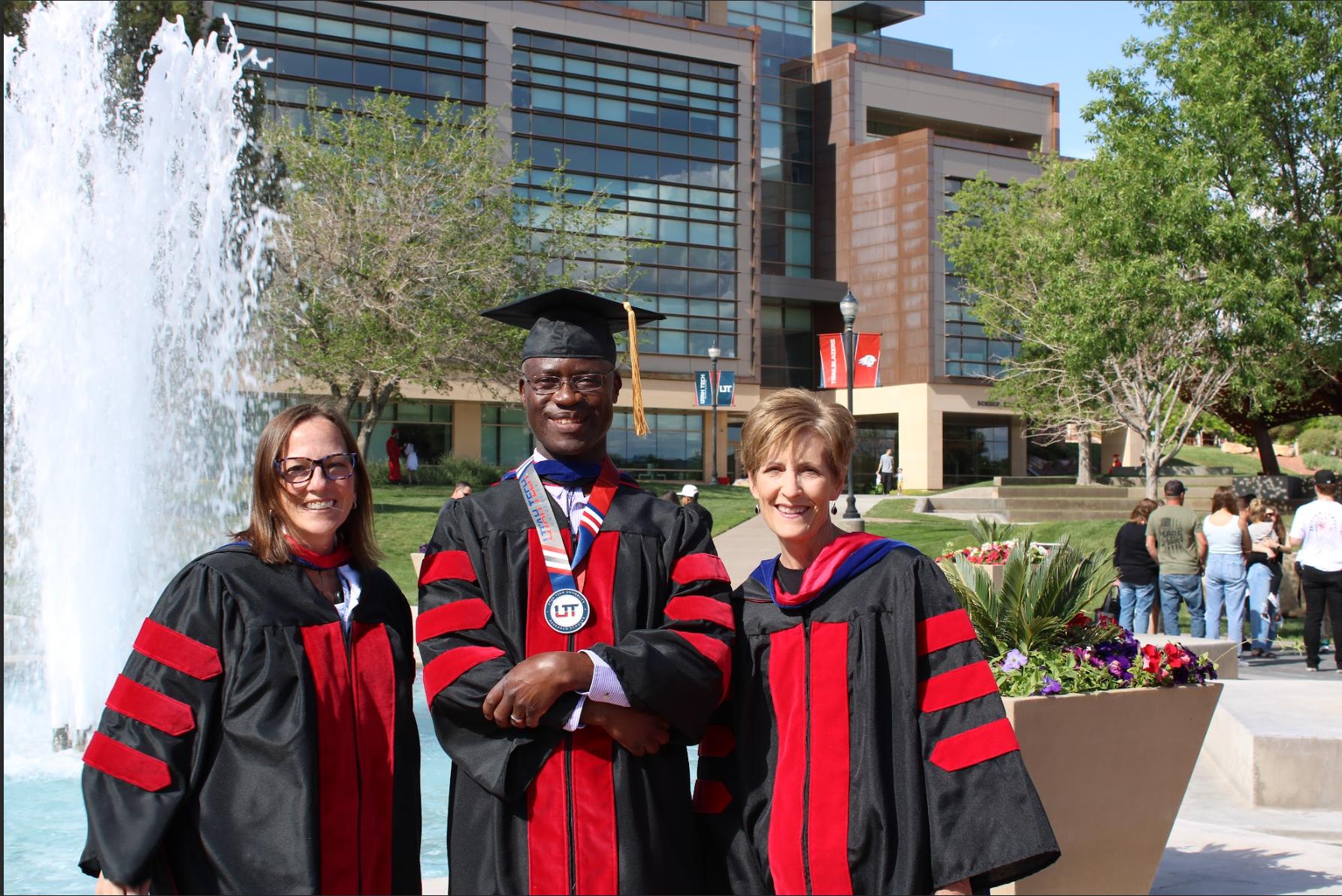 Healthcare professors Tiffany Vickers, Ph.D., CHES; Robert Kagabo, Ph.D., MSW, MPH, CHES; and Mary Brown, Ph.D., CHES pose on graduation day.