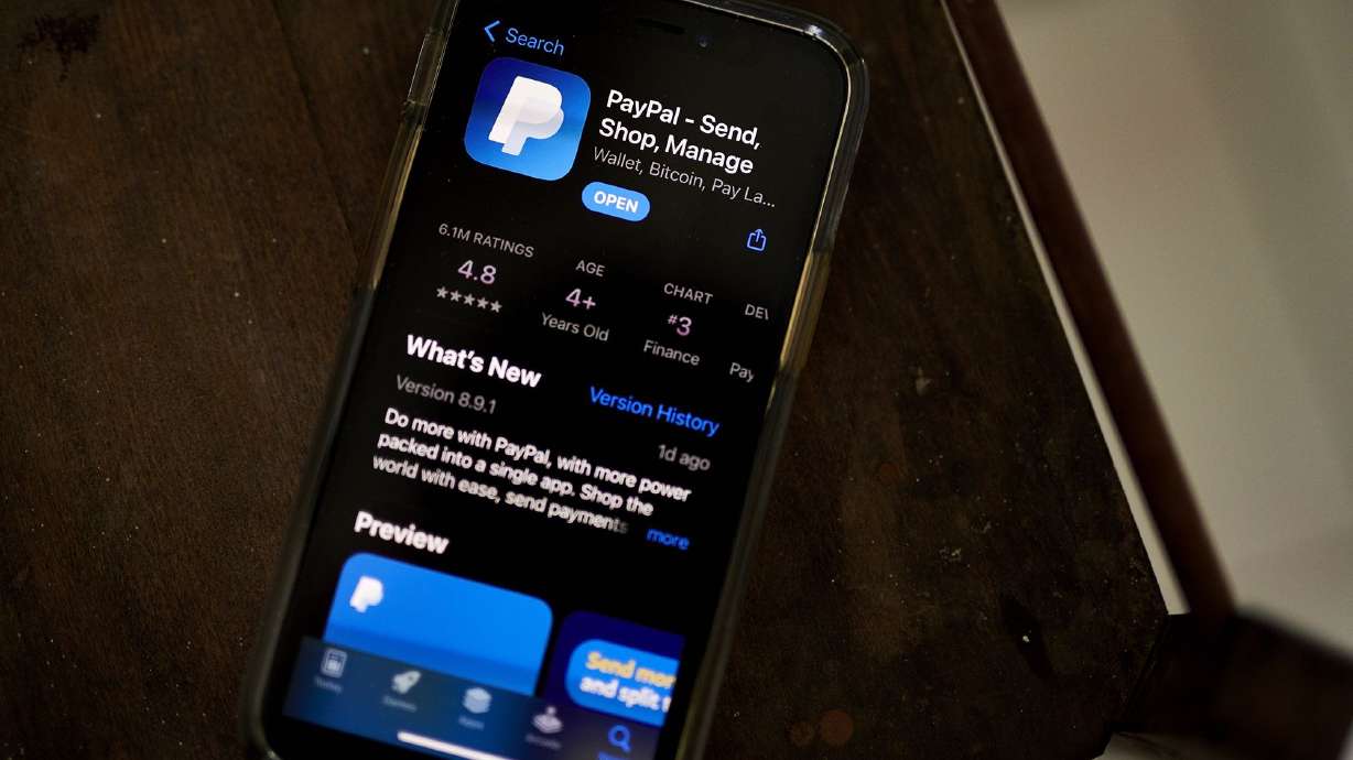 The PayPal application, seen here in the Apple App Store on a smartphone, is laying off 2,000 employees.