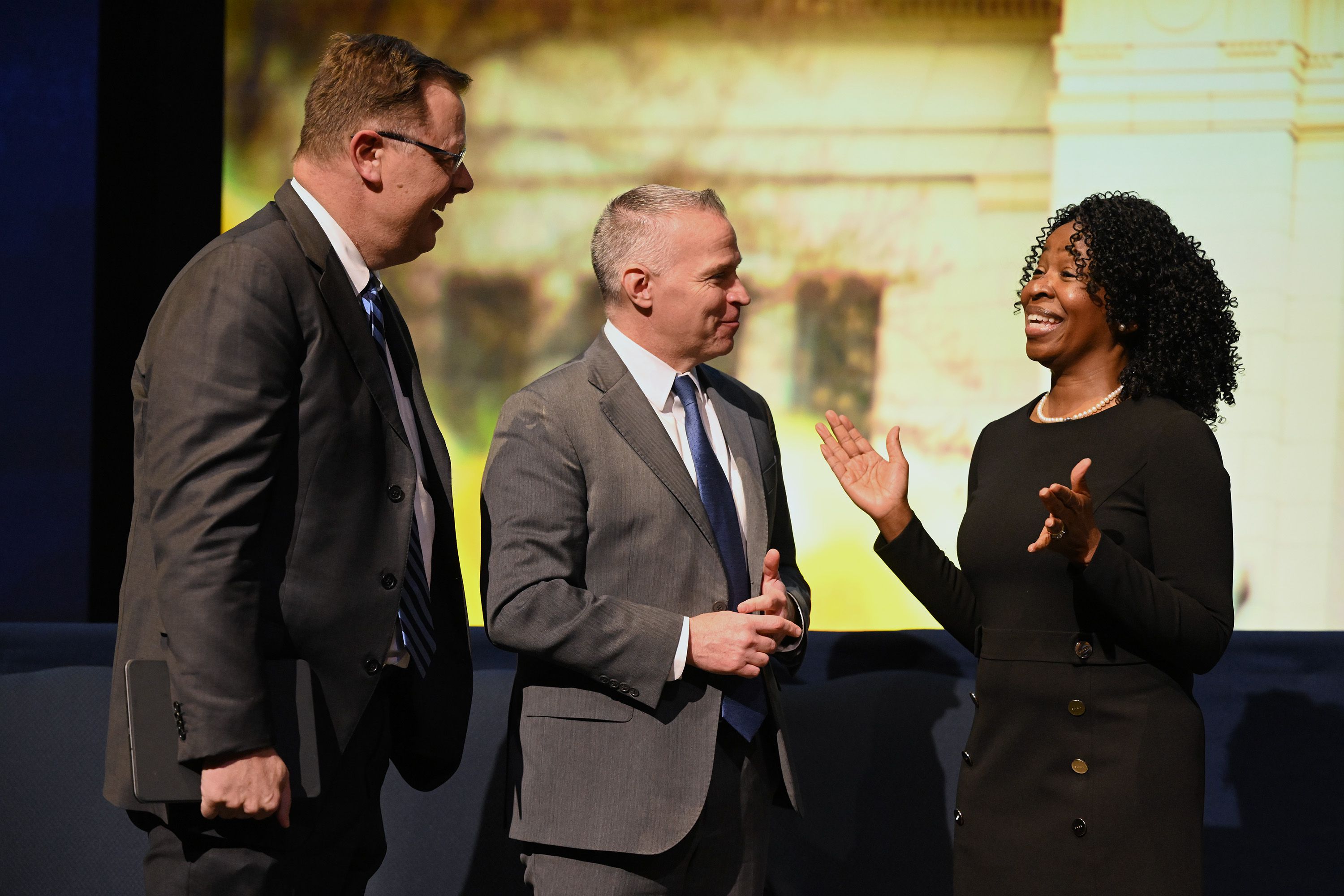 Clark G. Gilbert, left, a general authority seventy of The Church of Jesus Christ of Latter-day Saints, and BYU President C. Shane Reese talk with Ruth L. Okediji after she spoke at the BYU Forum at the Marriott Center in Provo on Tuesday.