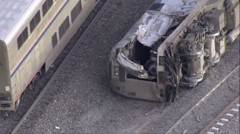 Emergency responders look over an Amtrak train derailment on Tuesday near Keenesburg, Colo.