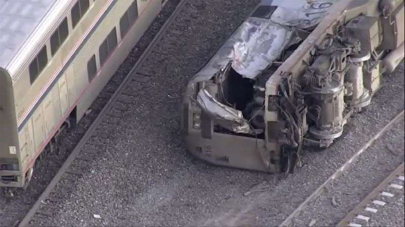 Emergency responders look over an Amtrak train derailment on Tuesday near Keenesburg, Colo.