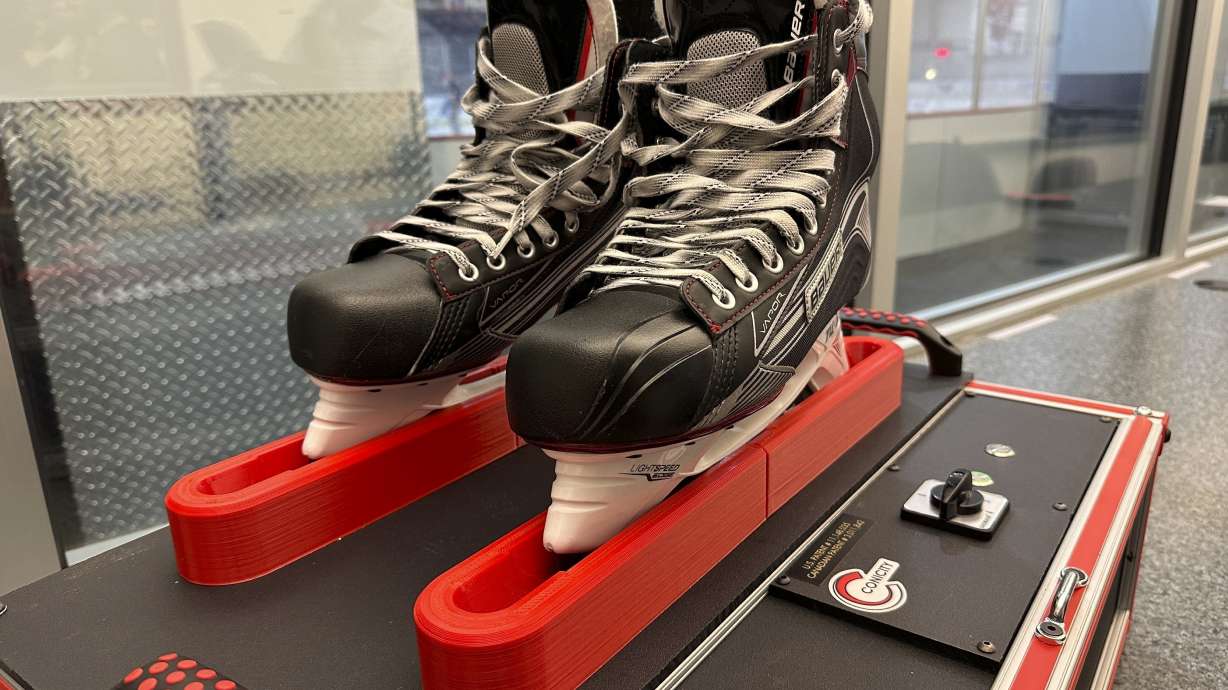 Skates sit in a Conicity Technologies’ grinding machine designed to remove tiny burrs from the metal blades, at the Washington Capitals NHL hockey team practice facility in Arlington, Virginia, Nov. 28, 2023. Dr. Bill Shaffer and son Luke, who come from a metal-cutting background, designed and built the machine they say can dramatically reduce the cutting qualities of skate blades while also keeping them sharp and allowing for better gliding along ice. The death of American hockey player Adam Johnson from a skate cut to the neck during a game in England has led to plenty of talk about how to prevent such injuries in the fast-paced sport, including a new neck laceration protection mandate in the U.S.