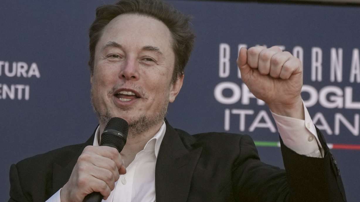 Tesla CEO Elon Musk waves in Rome, Dec. 16, 2023. A judge says Musk must give up a compensation package awarded by Tesla's board of directors that is potentially worth more than $55 billion.