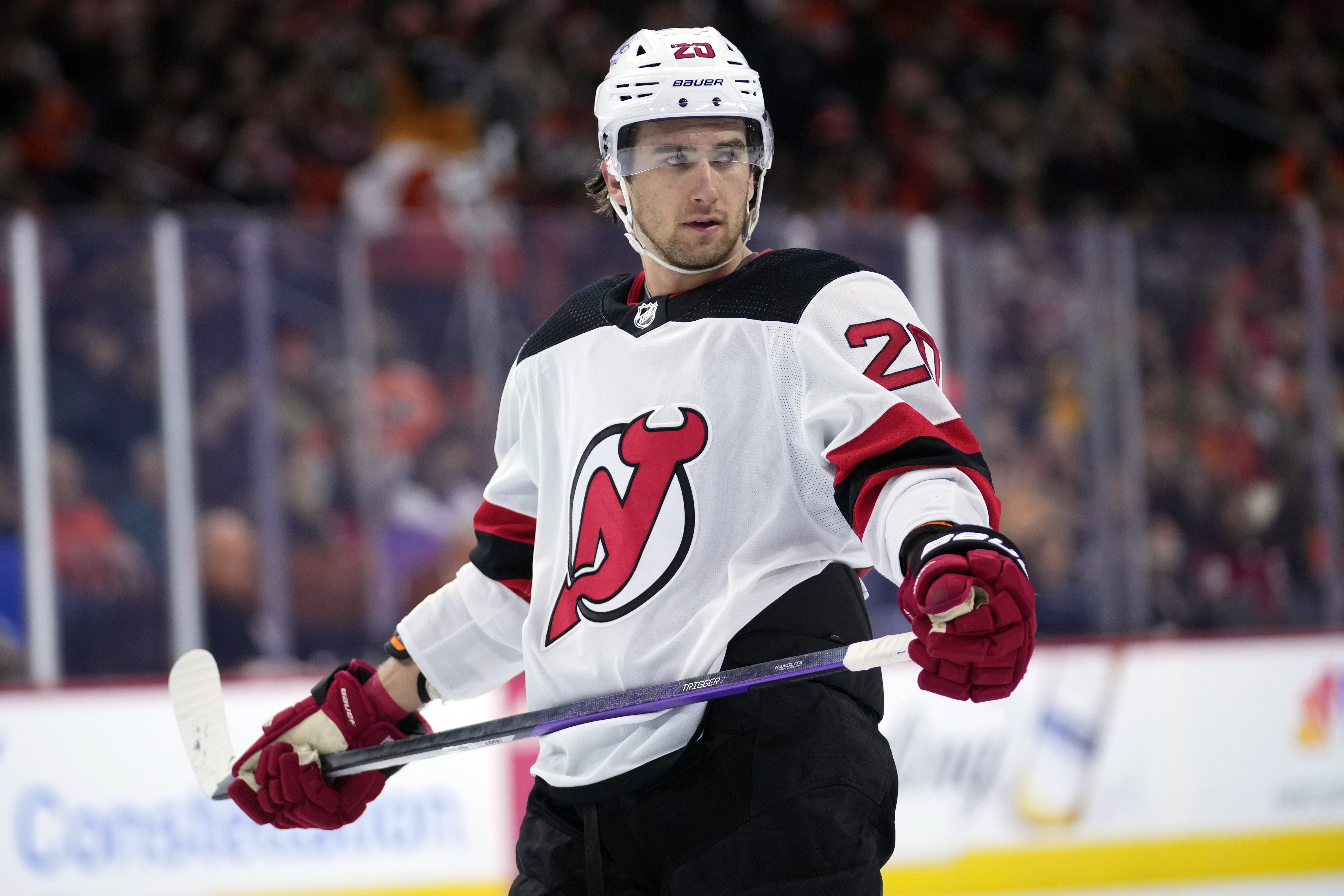 FILE - New Jersey Devils' Michael McLeod watches during a break in an NHL hockey game, Thursday, Nov. 30, 2023, in Philadelphia. Five players from Canada's 2018 world junior team have taken a leave of absence from their respective clubs in recent days amid a report that five members of that team have been asked to surrender to police to face sexual assault charges. New Jersey’s Michael McLeod and Cal Foote, Philadelphia’s Carter Hart, Calgary’s Dillon Dube and former NHL player Alex Formenton have all been granted indefinite leave, with the absences announced this week.