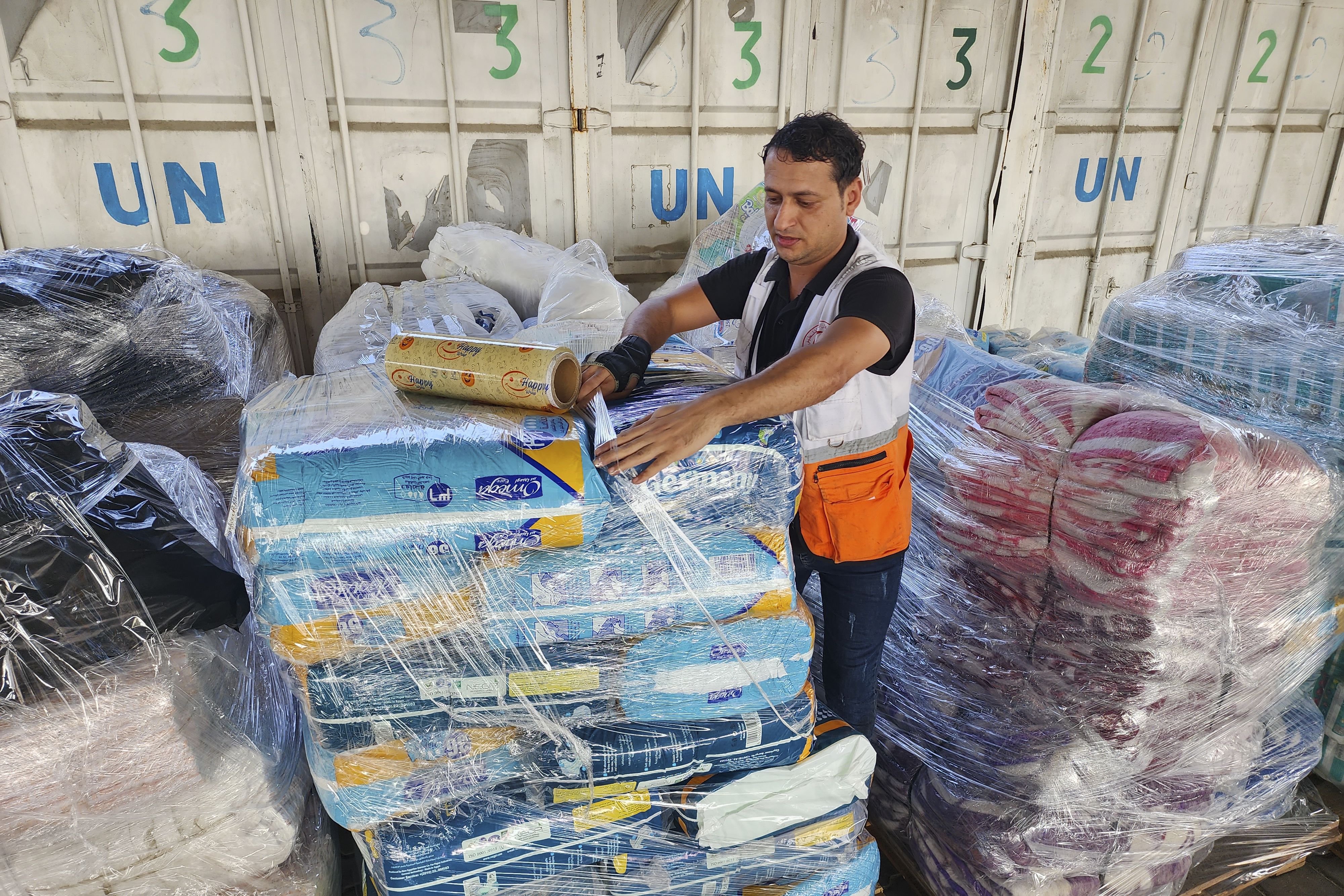 United Nations and Red Crescent workers prepare the aid for distribution to Palestinians at a United Nations Relief and Works Agency warehouse in Deir Al-Balah, Gaza Strip, on Oct. 23, 2023. Intelligence documents show that at least 12 employees from the United Nation's Palestinian refugee agency had involvement in the Oct. 7 attacks orchestrated by Hamas on Israel.