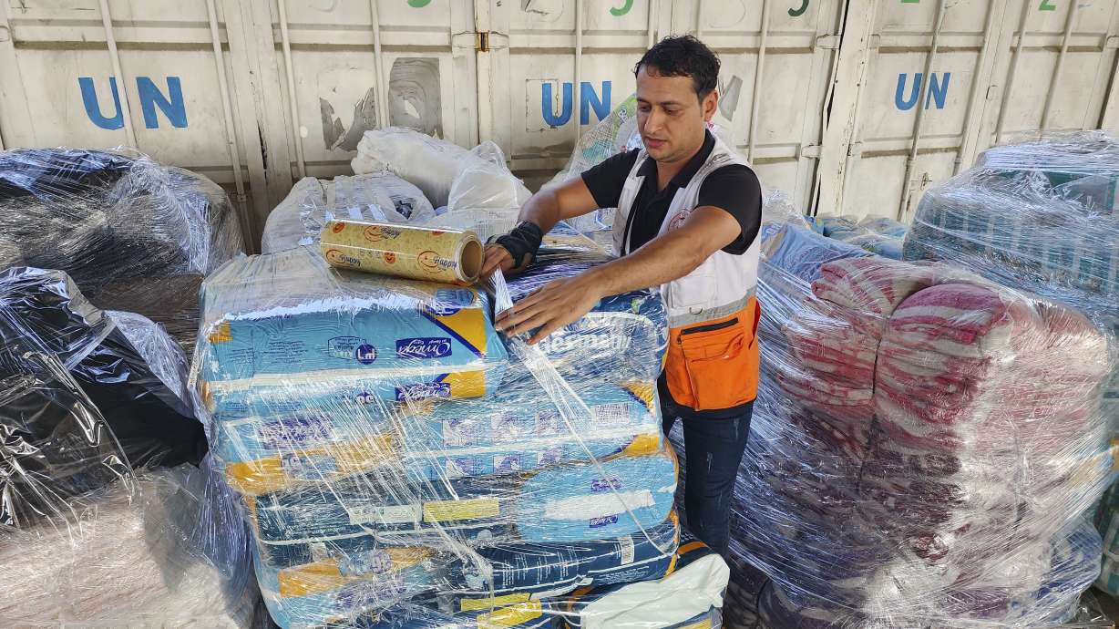 United Nations and Red Crescent workers prepare the aid for distribution to Palestinians at a United Nations Relief and Works Agency warehouse in Deir Al-Balah, Gaza Strip, on Oct. 23, 2023. Intelligence documents show that at least 12 employees from the United Nation's Palestinian refugee agency had involvement in the Oct. 7 attacks orchestrated by Hamas on Israel.