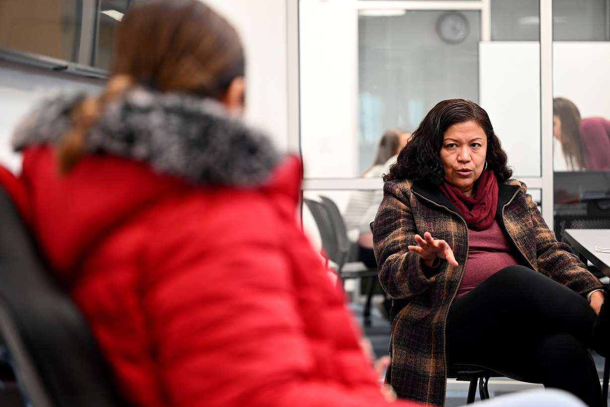 Gladis Rodriguez and Sofia Zelaya talk while at the Kearns Library waiting to assist anyone who might need help understanding the voting process for elections in El Salvador, on Friday.