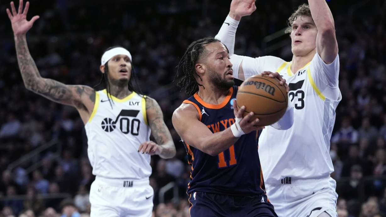 New York Knicks guard Jalen Brunson (11) looks to move the ball around Utah Jazz forward Lauri Markkanen (23) during the first half of an NBA basketball game, Tuesday, Jan. 30, 2024, at Madison Square Garden in New York.
