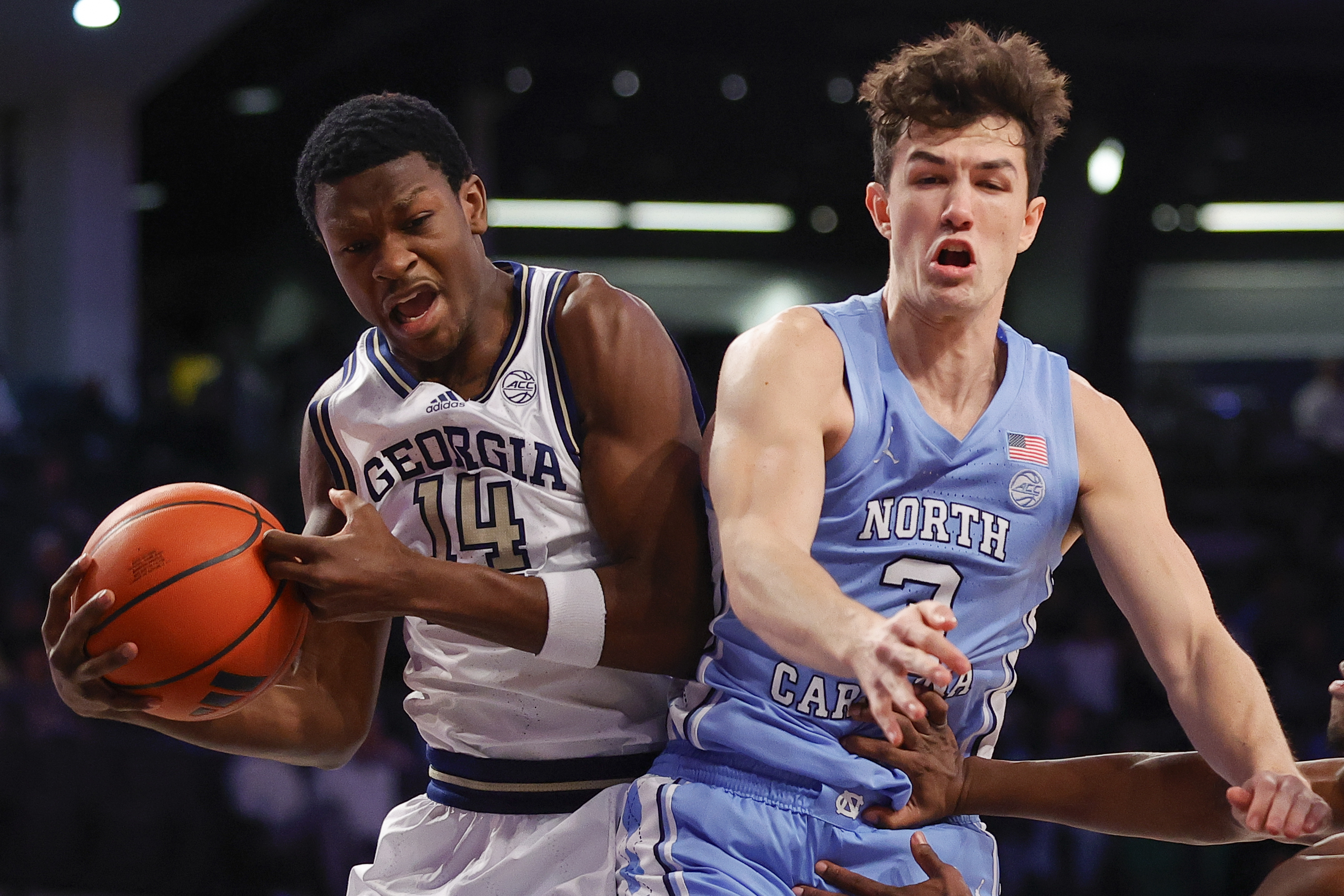 Georgia Tech guard Kowacie Reeves Jr. (14) rebounds the ball over North Carolina guard Cormac Ryan during the first half of an NCAA college basketball game Tuesday, Jan. 30, 2024, in Atlanta. 