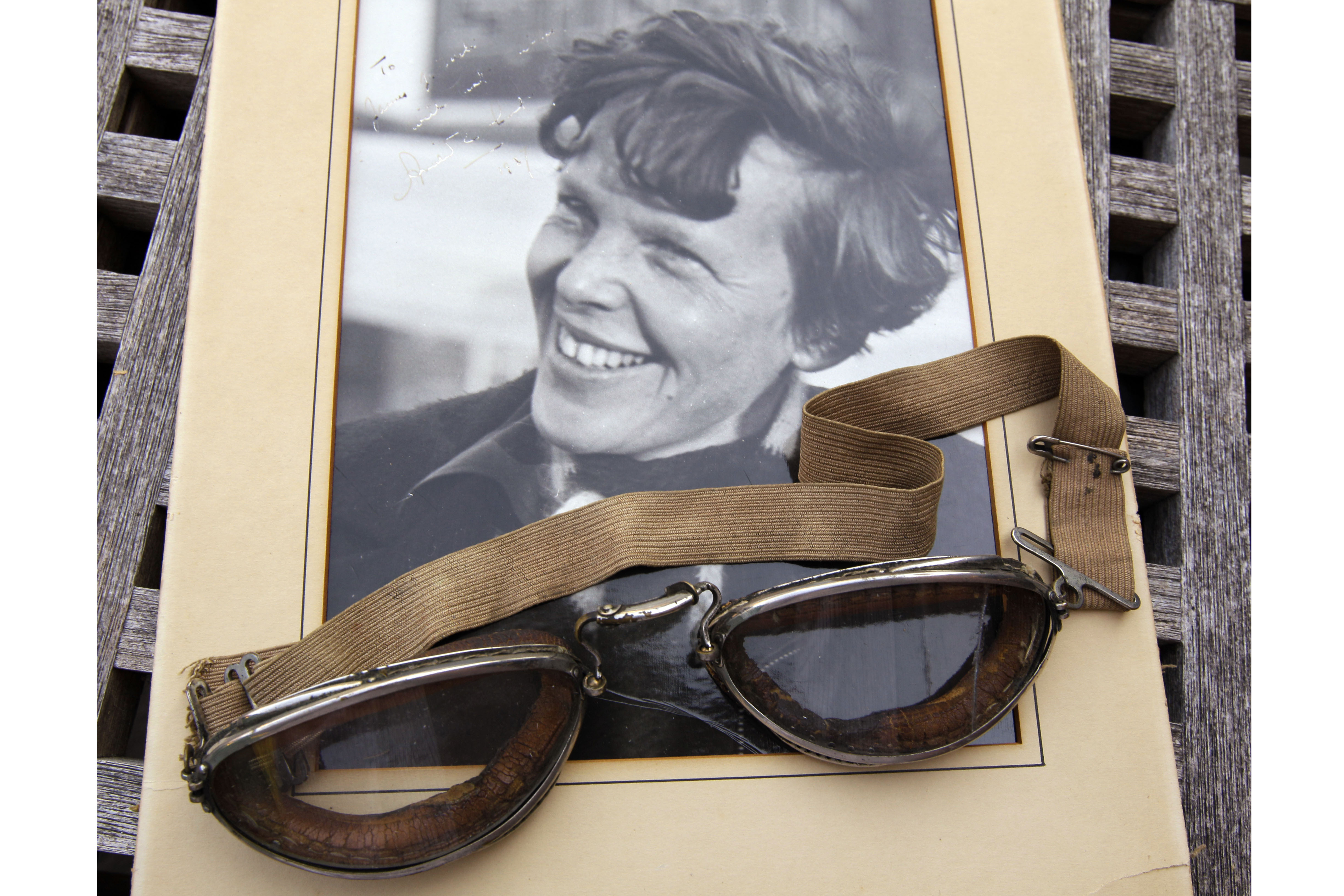An original, unpublished personal photo of Amelia Earhart dated 1937, along with goggles she was wearing during her first plane crash are seen Sept. 9, 2011, at Clars Auction Gallery in Oakland, Calif.