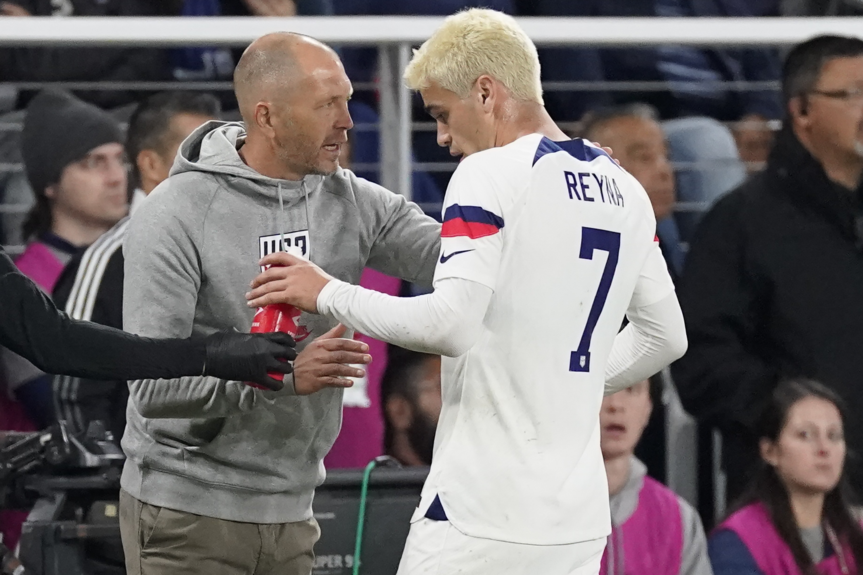 FILE - United States head coach Gregg Berhalter, left, talks to midfielder Gio Reyna (7) during the first half of an international friendly soccer match against Ghana, Tuesday, Oct. 17, 2023, in Nashville, Tenn. Berhalter understands why Reyna may leave Borussia Dortmund during the January transfer window. The 21-year-old midfielder has started just one Bundesliga match this season, playing the first half at Eintracht Frankfurt on Oct. 29. “Any professional who’s competitive wants to be on the field,” Berhalter said Friday, Jan. 19, 2024. 