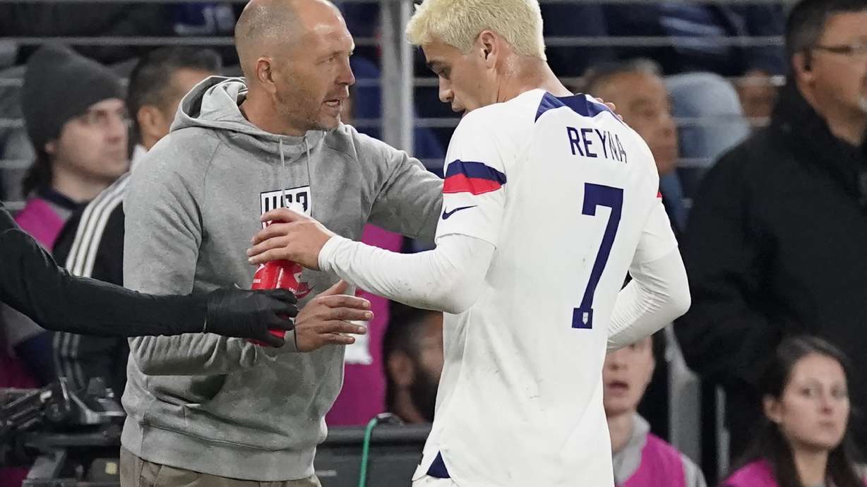 FILE - United States head coach Gregg Berhalter, left, talks to midfielder Gio Reyna (7) during the first half of an international friendly soccer match against Ghana, Tuesday, Oct. 17, 2023, in Nashville, Tenn. Berhalter understands why Reyna may leave Borussia Dortmund during the January transfer window. The 21-year-old midfielder has started just one Bundesliga match this season, playing the first half at Eintracht Frankfurt on Oct. 29. “Any professional who’s competitive wants to be on the field,” Berhalter said Friday, Jan. 19, 2024.