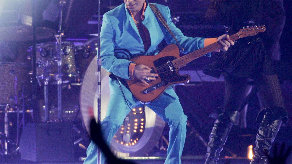 FILE - Prince performs during the halftime show at the Super Bowl XLI NFL football game at Dolphin Stadium in Miami on Sunday, Feb. 4, 2007. When the Super Bowl halftime show was born, high school and college marching bands took center field. But over the years, the intermission during the NFL’s championship game has turned into one of sports’ biggest spectacles with superstar performances.