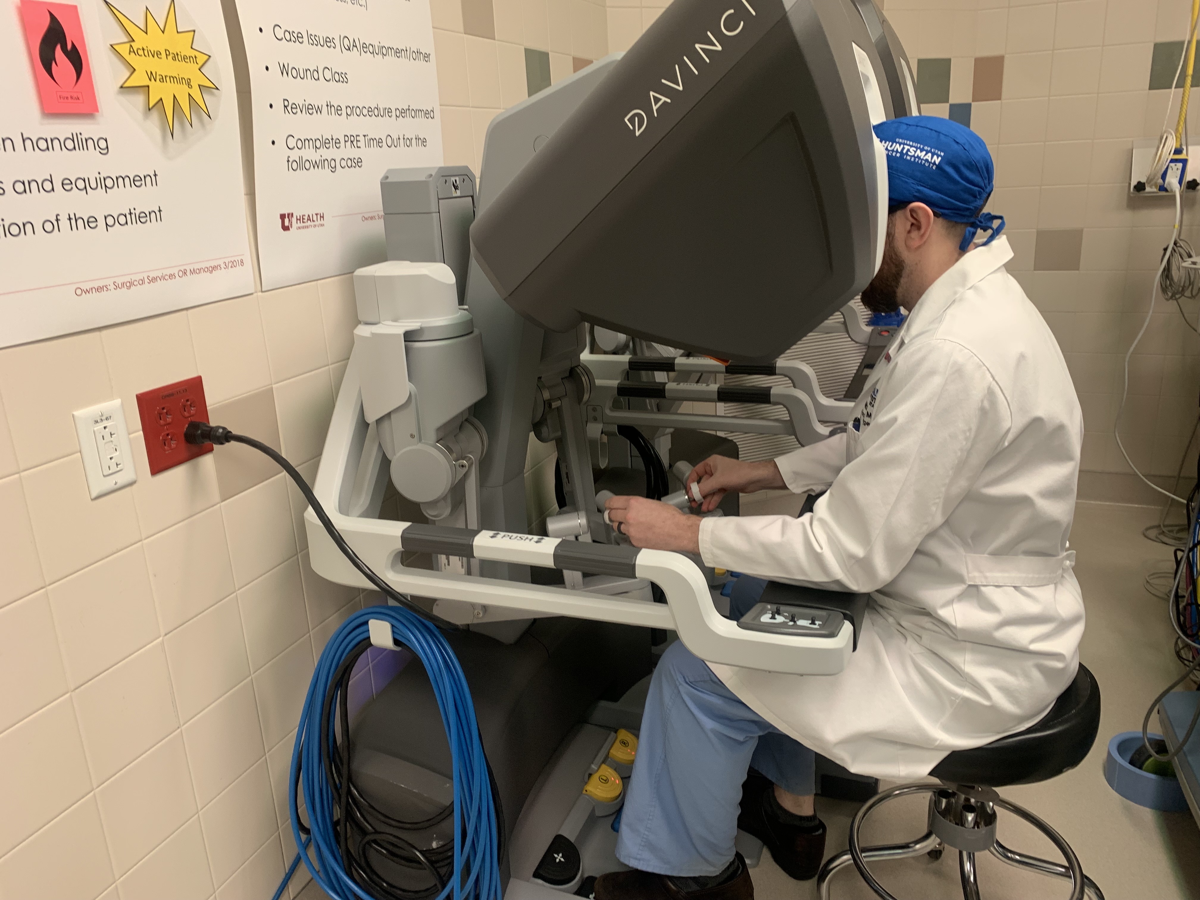 Dr. Brian Mitzman sits at the console of the DaVinci single-port robot, a surgical machine that is new to the Huntsman Cancer Institute, on Jan. 24. Use of robots like DaVinci SP in surgery can make the process smoother for doctors and patients.