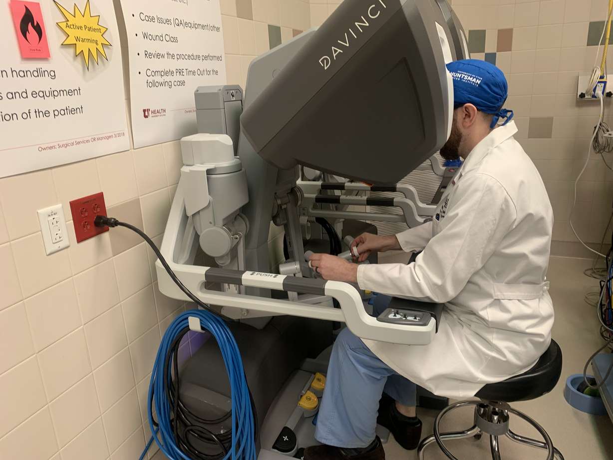 Dr. Brian Mitzman sits at the console of the DaVinci single-port robot, a surgical machine that is new to the Huntsman Cancer Institute, on Jan. 24. Use of robots like DaVinci SP in surgery can make the process smoother for doctors and patients.