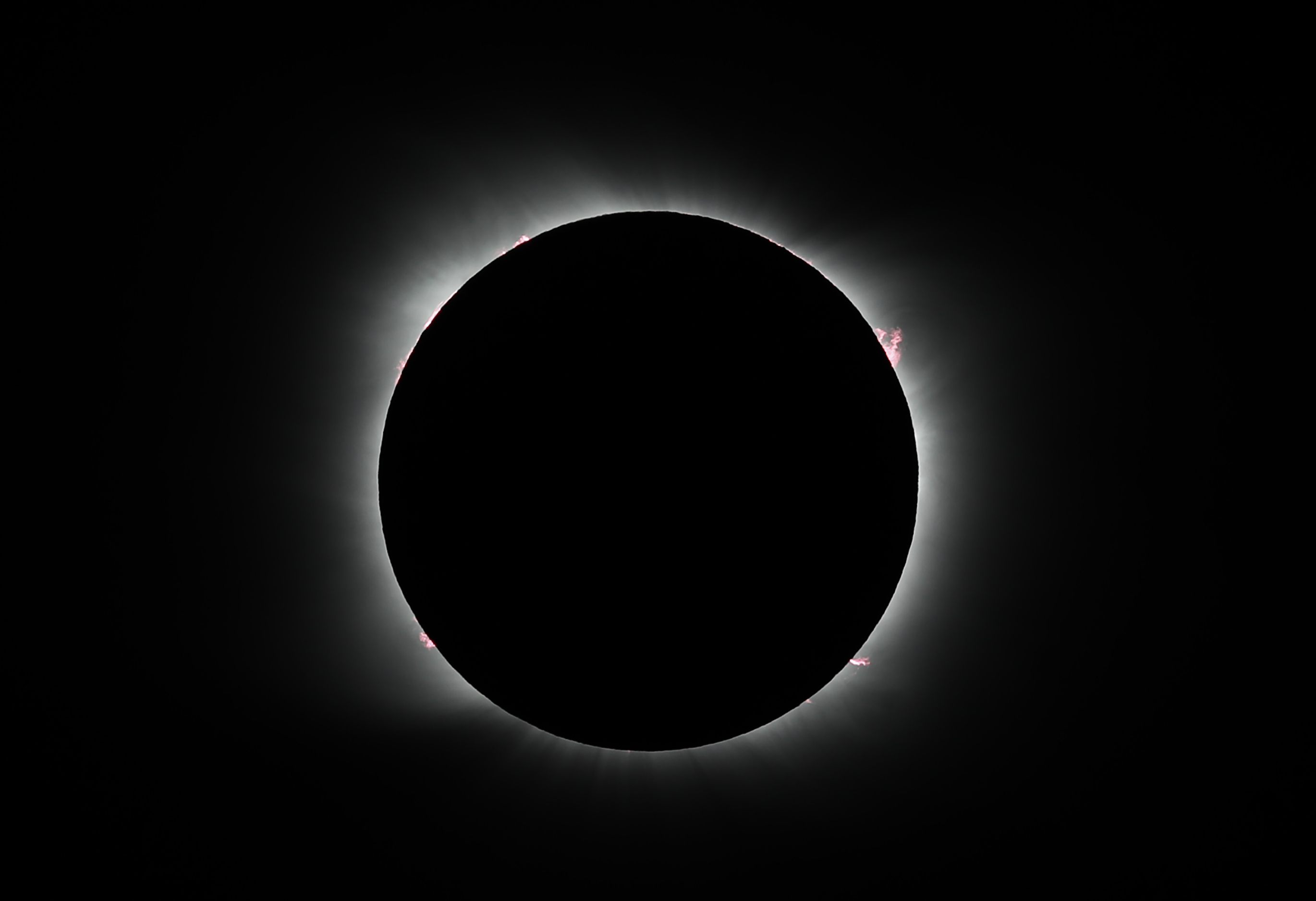 FILE - The moon covers the sun during a solar eclipse in Piedra del Aguila, Argentina, Monday, Dec. 14, 2020. Officials are estimating 200,000 visitors will descend upon Cleveland April 8, 2024, to view a total solar eclipse — a once-in-generations event. The Cleveland Guardians baseball team has their home opener the same day. The Guardians have started their home openers in recent years with a 4:10 p.m. first pitch. This year, though, that falls in the partial-eclipse window. The team is weighing whether to embrace the eclipse and open the ballpark earlier to allow fans to watch the eclipse together — an opening act on opening day. 