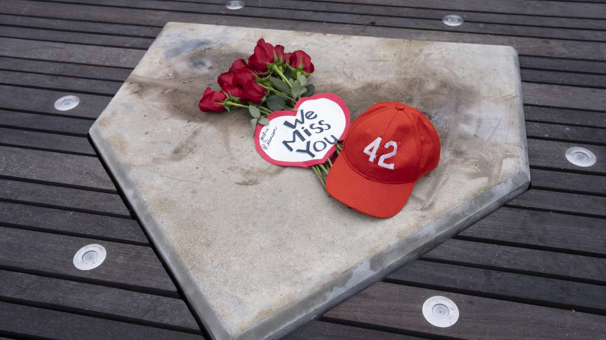 A group of people gathered at the baseball legend Jackie Robinson pavilion at McAdams Park in Wichita, Kan. on Saturday, Jan. 27, 2024. A bronze statue of Jackie Robinson was cut down and stolen from this spot on Thursday, Jan. 25, 2024. A youth baseball league called League 42 plays in the park. The statue is valued at $75,000.