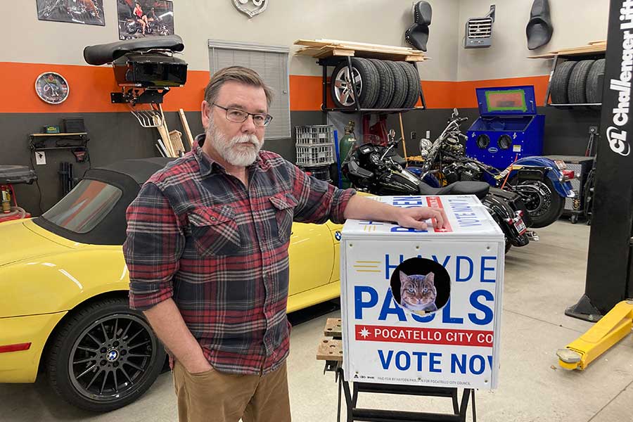 Kelly Boodry stands next to one of his cat shelters recently.