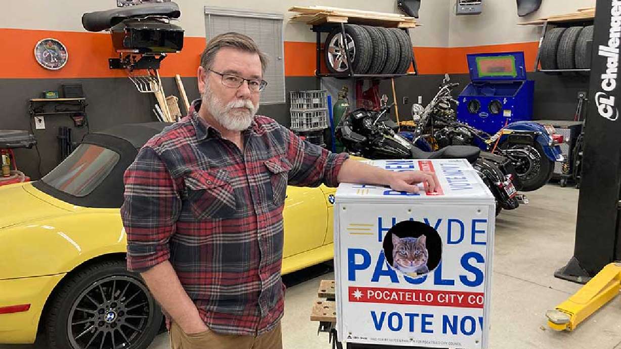 Kelly Boodry stands next to one of his cat shelters recently.