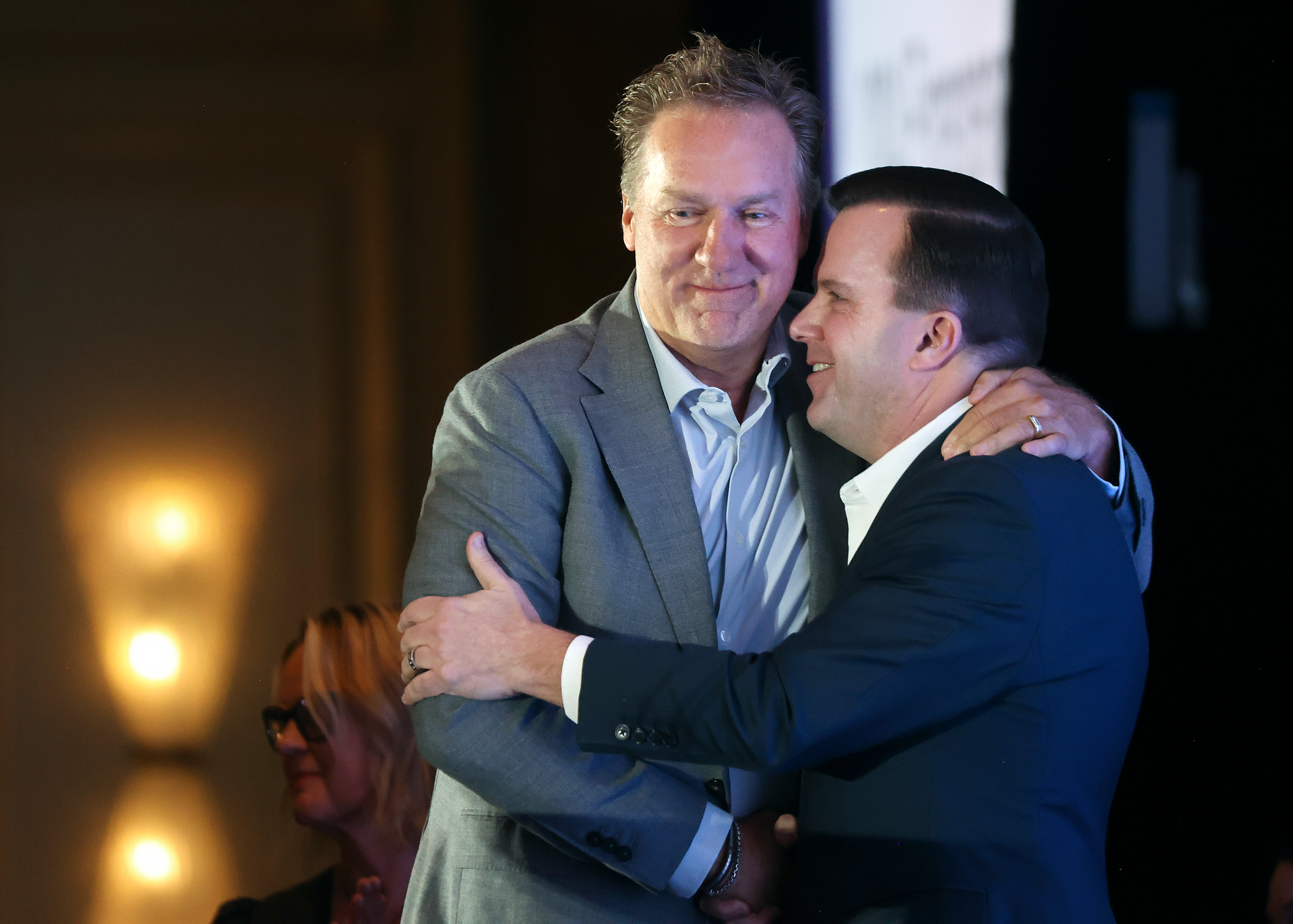 David S. Layton, Layton Construction president and CEO, hugs Rob Brough, Zions Bank executive vice president, as Layton is honored as the MountainWest Capital Network Entrepreneur of the Year on Wednesday in Salt Lake City.