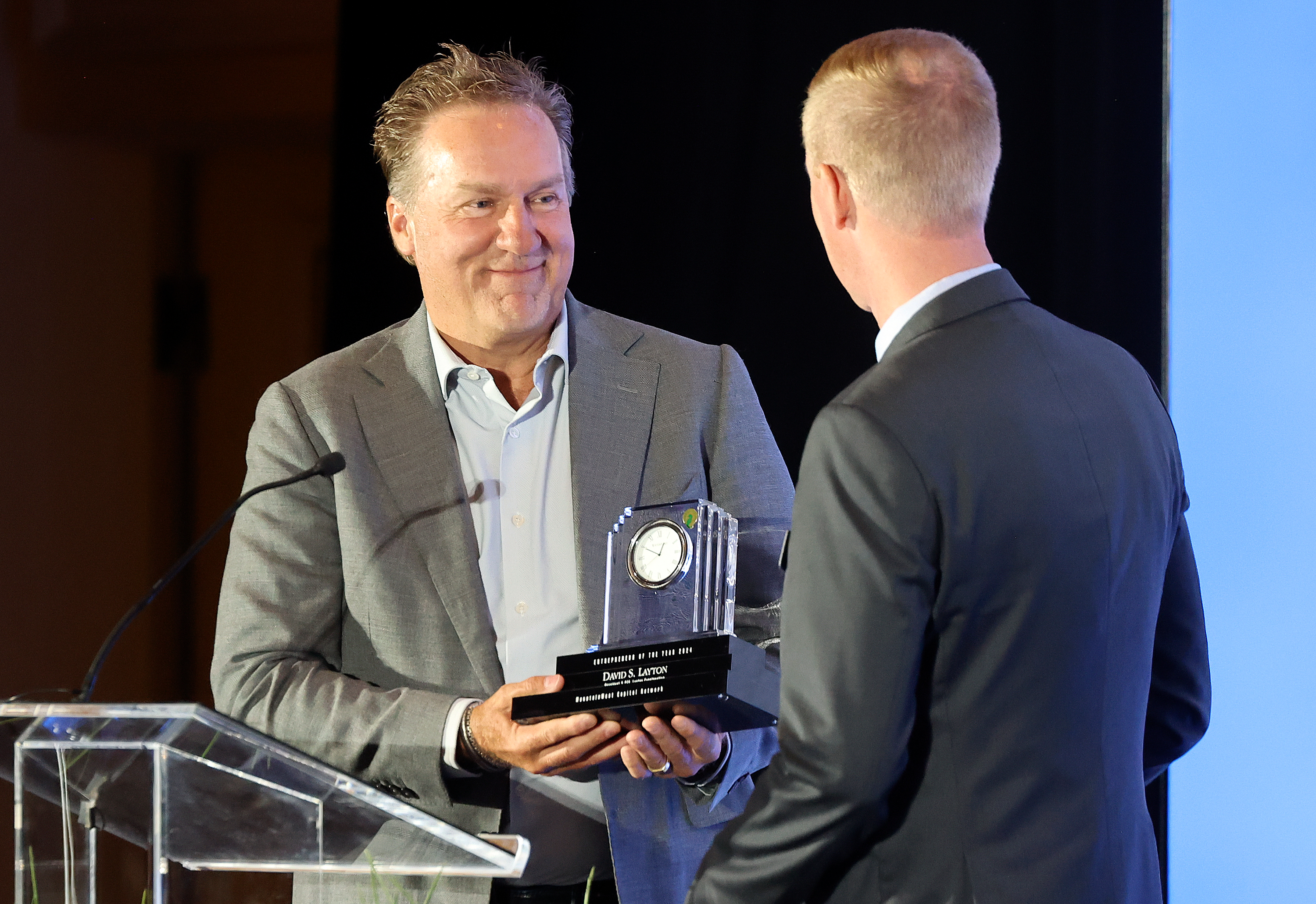 David S. Layton, Layton Construction president and CEO, receives the MountainWest Capital Network Entrepreneur of the Year award from Steve Wilson, MountainWest Capital Network trustee, at the Little America Hotel in Salt Lake City on Wednesday.