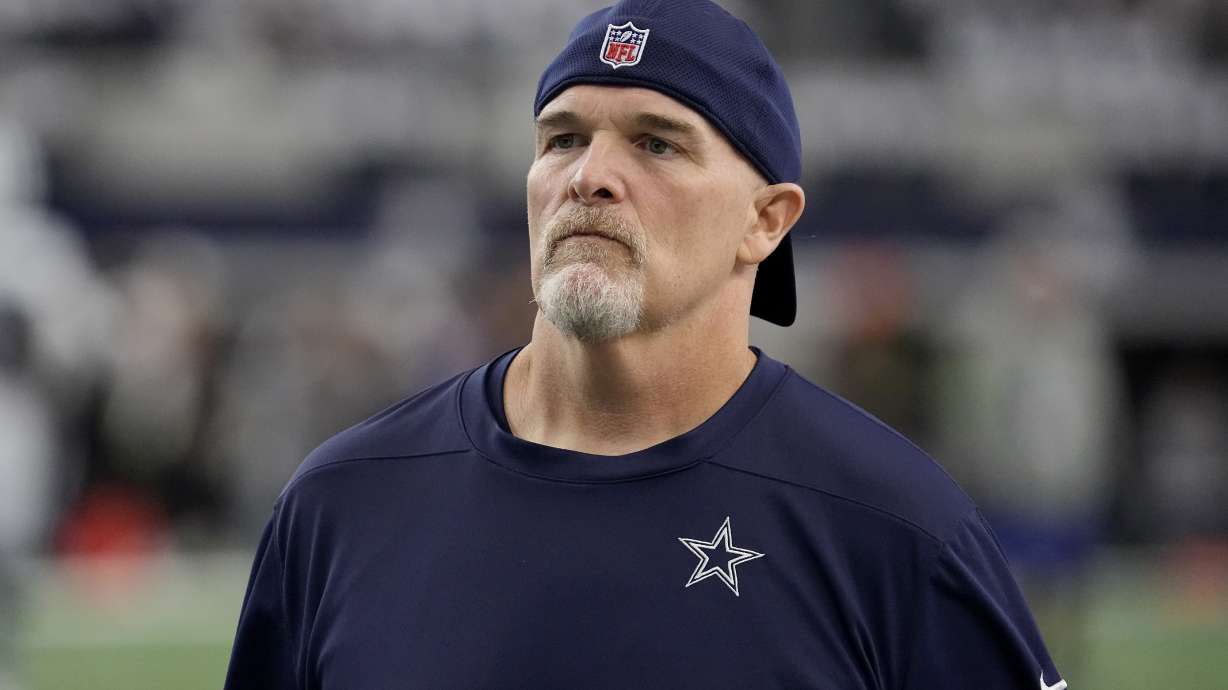 FILE - Dallas Cowboys defensive coordinator Dan Quinn watches players warm up for an NFL football game against the Washington Commanders on Nov. 23, 2023, in Arlington, Texas. Quinn was the 12th candidate to interview for the Los Angeles Chargers head coach opening. Quinn just completed his third season with the Cowboys. He was the Falcons head coach for five-plus seasons (2015-20), where he went 43-42 with a Super Bowl berth after the 2016 season.