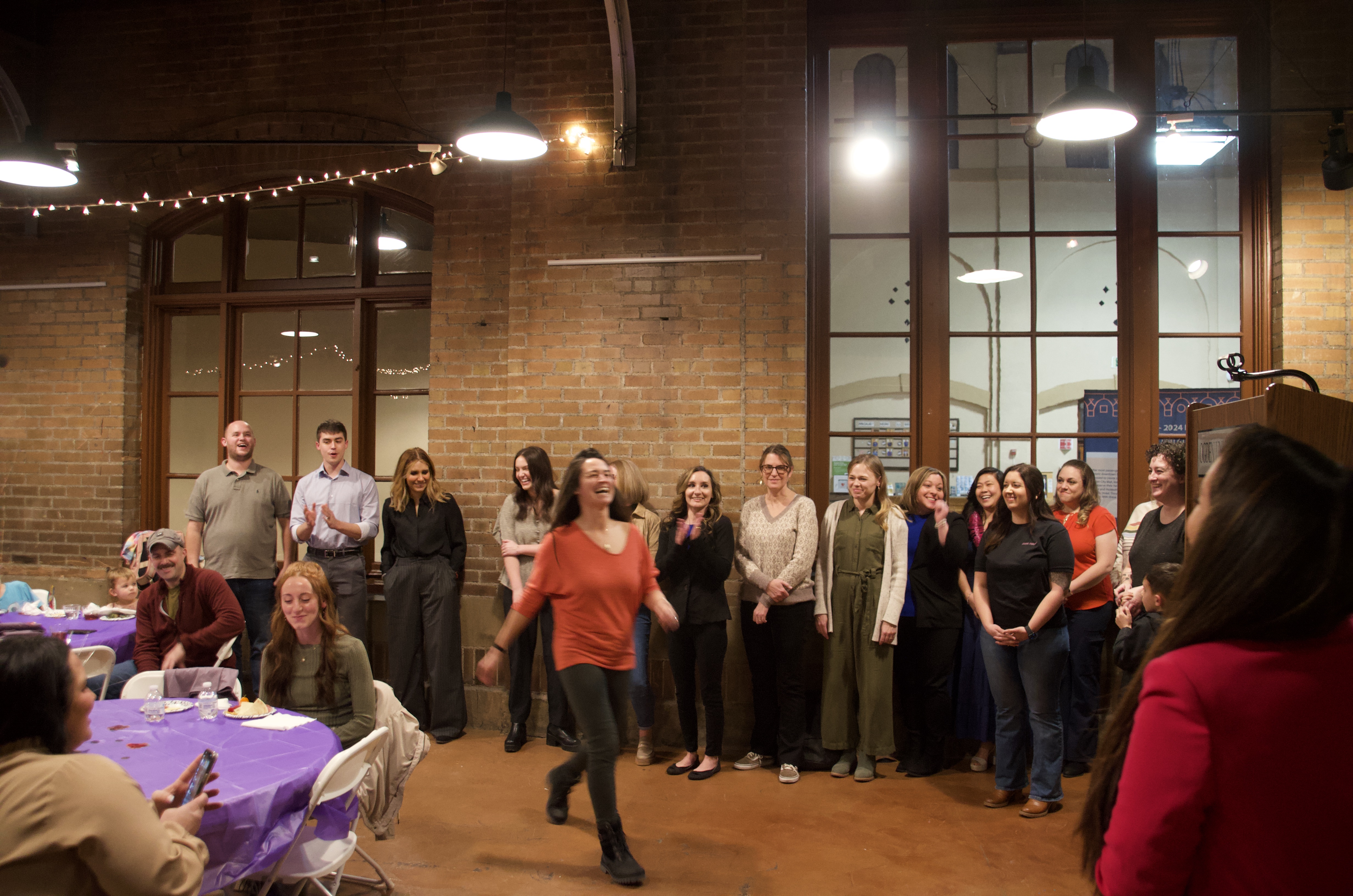 Graduates from the Rosie Project's second cohort cheer for each other as they accept their certificates on Wednesday.