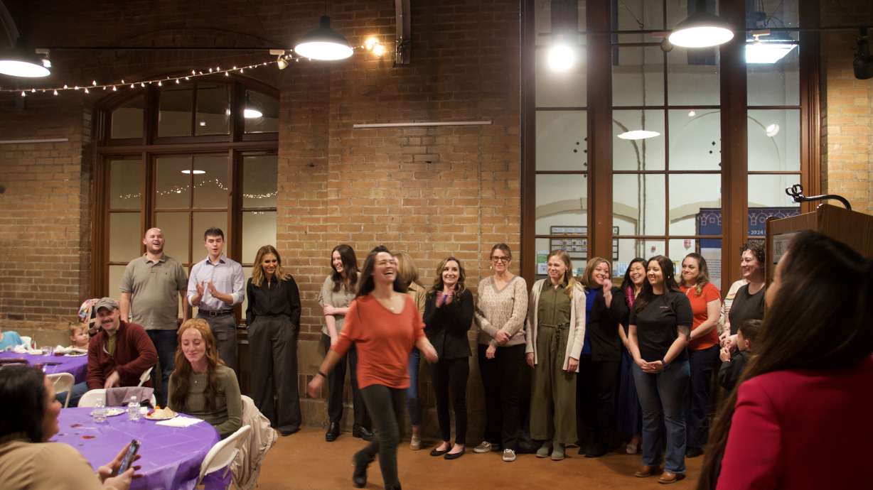 Graduates from the Rosie Project's second cohort cheer for each other as they accept their certificates on Wednesday.