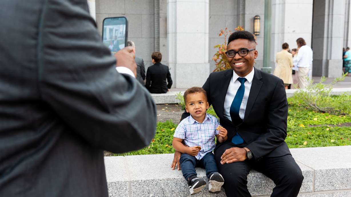 Davis Ebohon poses with his son Ikponmwosa Ebohon before the 193rd Semiannual General Conference of The Church of Jesus Christ of Latter-day Saints in Salt Lake City on Sept. 30, 2023.