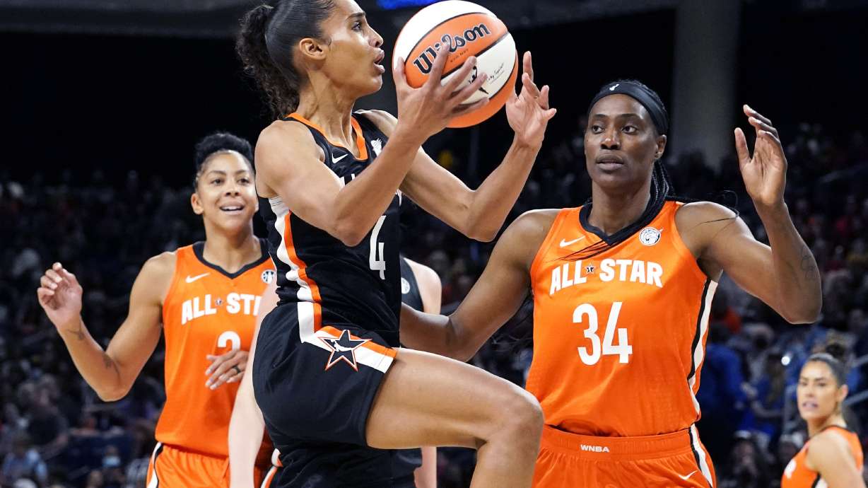 FILE - Team Stewart's Skylar Diggins-Smith, center, drives to the basket against Team Wilson's Candace Parker, left, and Sylvia Fowles during the first half of a WNBA All-Star basketball game in Chicago, Sunday, July 10, 2022. Seattle signed Skylar Diggins-Smith as WNBA free agency tipped off Thursday, Feb. 1, 2024.