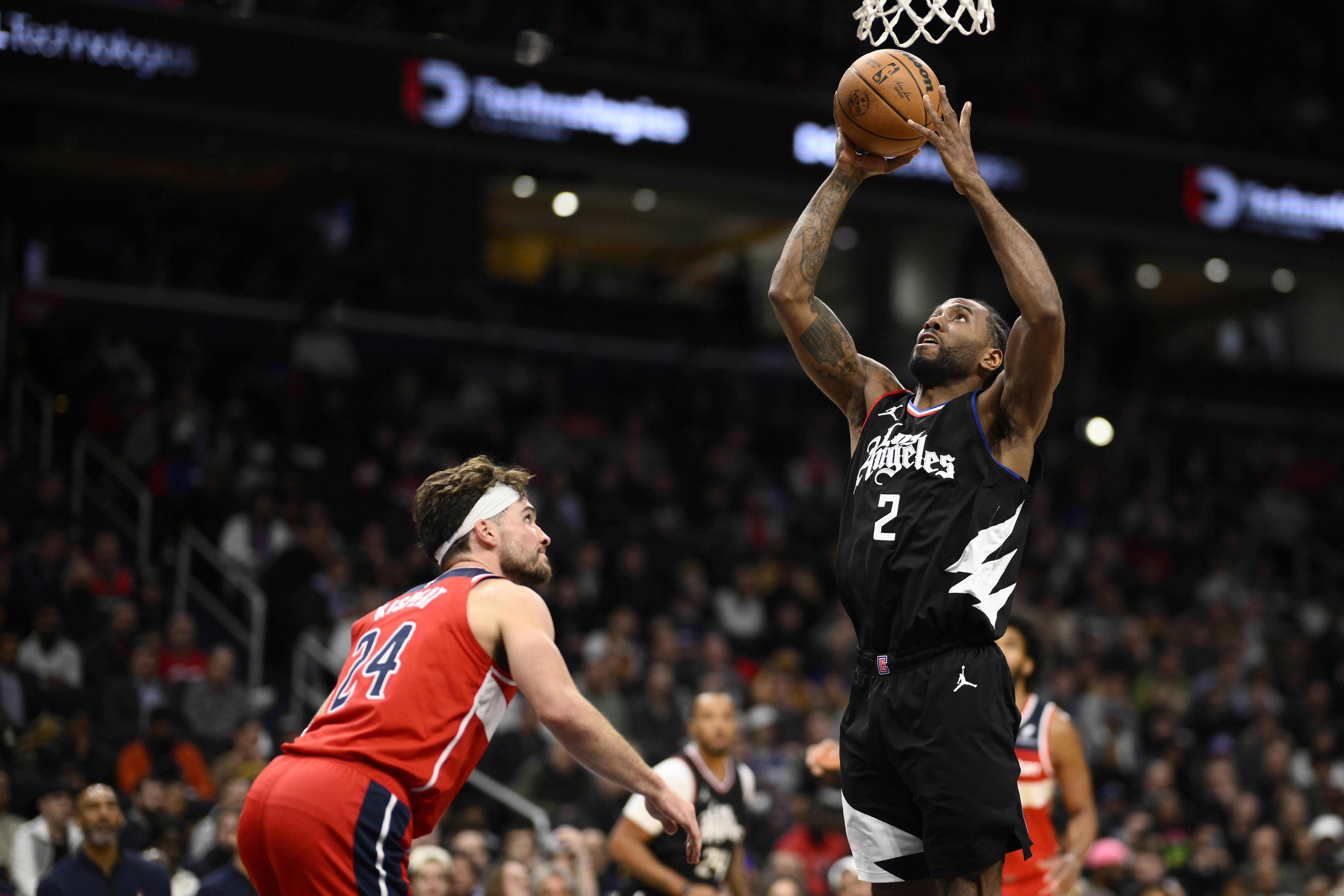 Los Angeles Clippers forward Kawhi Leonard (2) goes to the basket against Washington Wizards forward Corey Kispert (24) during the first half of an NBA basketball game, Wednesday, Jan. 31, 2024, in Washington. 