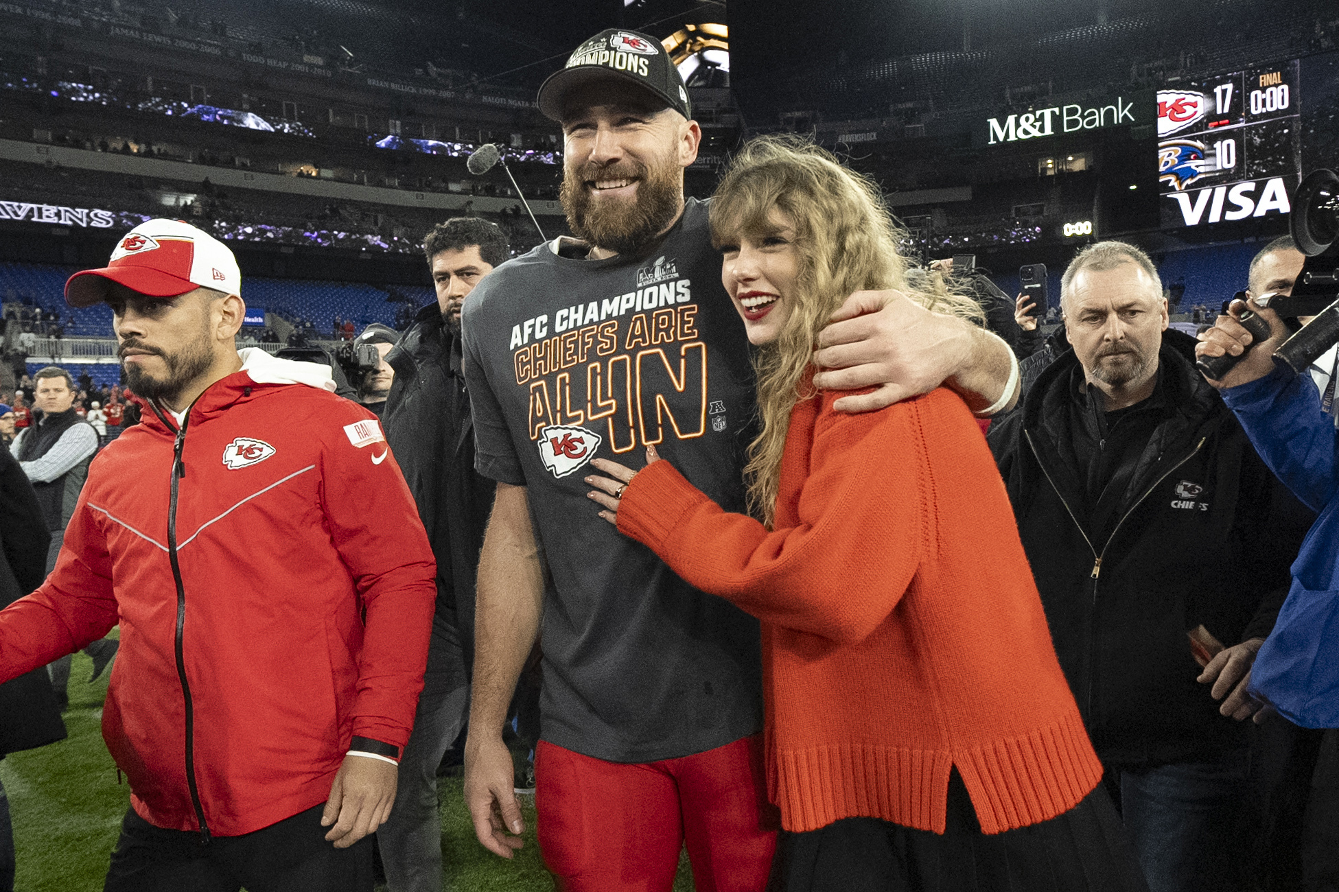 FILE - Kansas City Chiefs tight end Travis Kelce walks with Taylor Swift following the AFC Championship NFL football game between the Baltimore Ravens and the Kansas City Chiefs, Sunday, Jan. 28, 2024, in Baltimore. As the Kansas City Chiefs head to the Super Bowl, baseless conspiracy theories are spreading on social media suggesting that the romance between megastar Taylor Swift and Kansas City Chiefs tight end Travis Kelce is part of a secret plot to help President Joe Biden get reelected in 2024. 