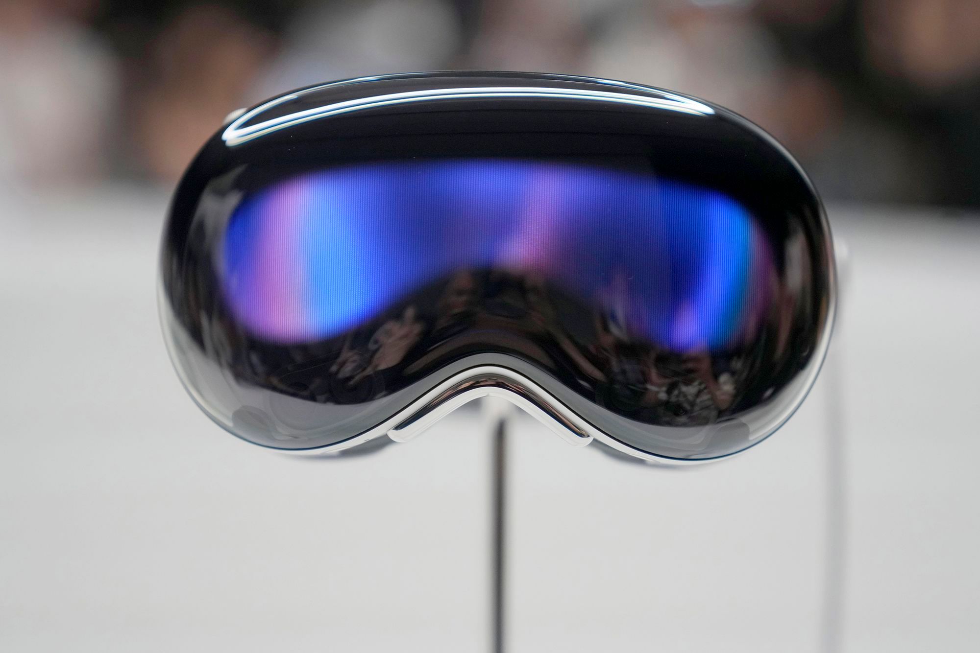 The Apple Vision Pro headset is displayed in a showroom on the Apple campus after it's unveiling on June 5, 2023, in Cupertino, Calif. The Vision Pro is a high-priced headset that blends virtual reality with augmented reality that projects digital images on top of real-world settings.