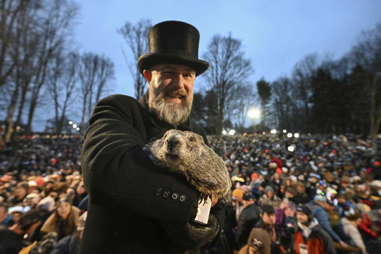 Groundhog Club handler A.J. Dereume holds Punxsutawney Phil, the weather prognosticating groundhog, during the 138th celebration of Groundhog Day on Gobbler's Knob in Punxsutawney, Pa., Friday. Phil's handlers said the groundhog has forecast an early spring.
