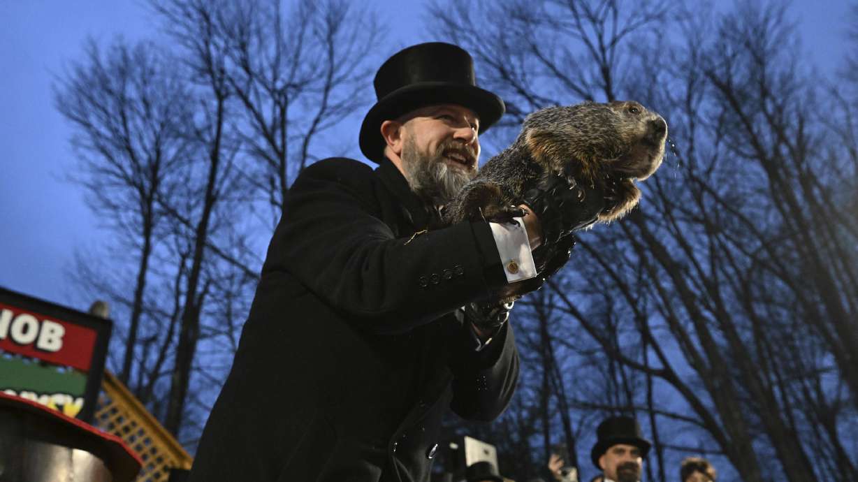 Groundhog Club handler A.J. Dereume holds Punxsutawney Phil during the 138th celebration of Groundhog Day on Gobbler's Knob in Punxsutawney, Pa., Friday. Phil's handlers said the groundhog has forecast an early spring.