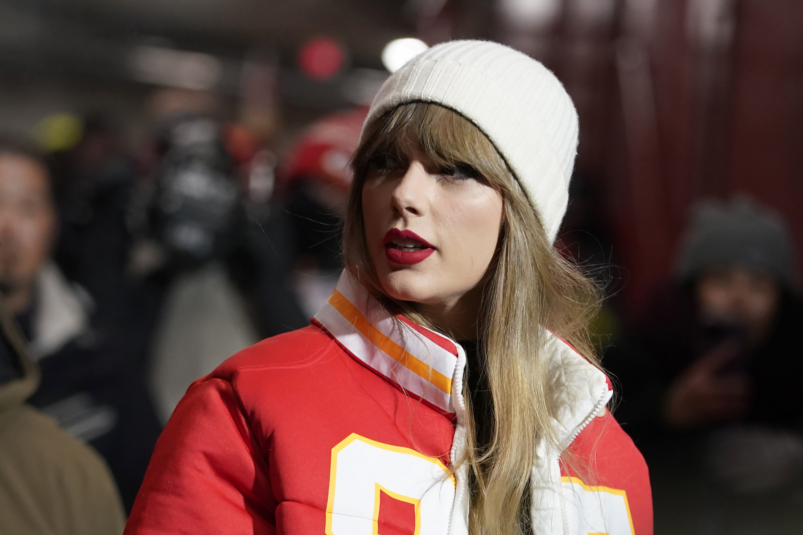 FILE - Taylor Swift arrives before an NFL wild-card playoff football game between the Kansas City Chiefs and the Miami Dolphins, Jan. 13, 2024, in Kansas City, Mo. For weeks, scrutiny over Swift’s travel has been bubbling up on social media, with people pointing out the planet-warming emissions of carbon dioxide released with every flight.