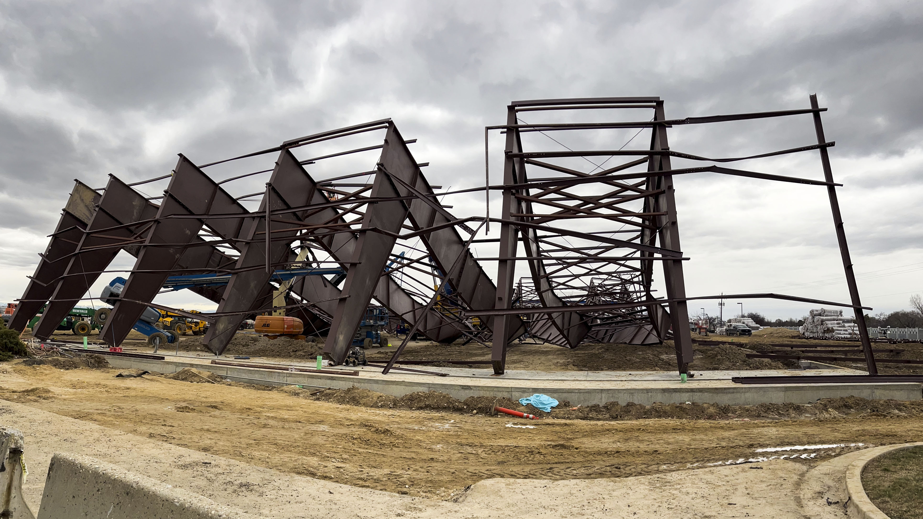 Twisted girders and debris cover the ground from a deadly structure collapse at a construction site near the Boise Airport on Thursday, in Boise.