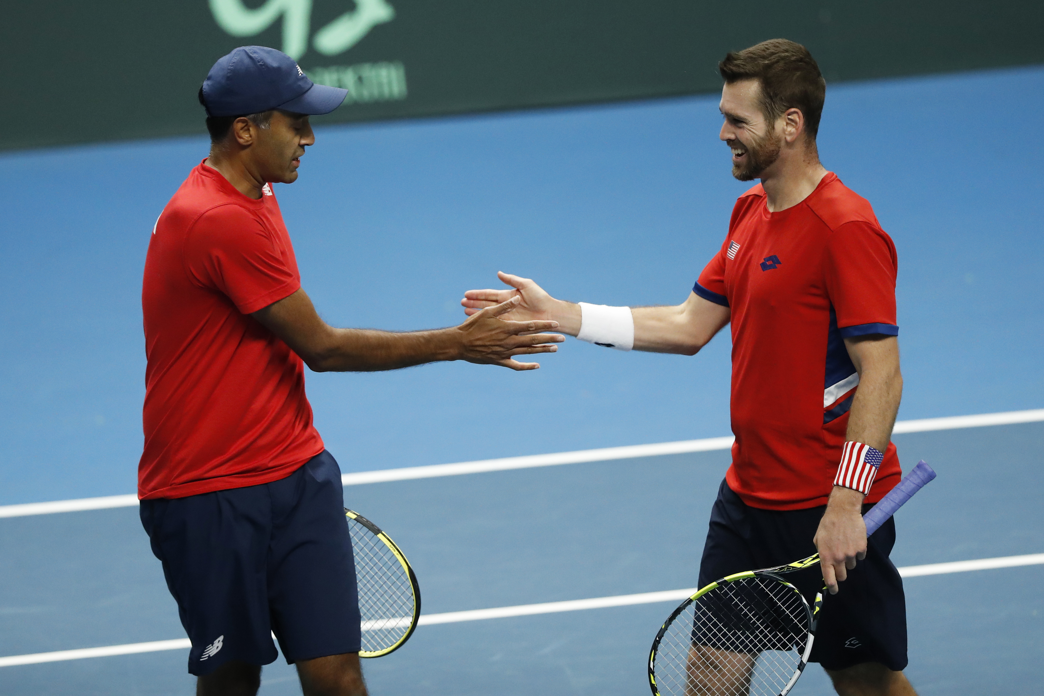 Rajeev Ram, left, and Austin Krajicek of the USA react during their match against Illya Beloborodko and Oleksii Krutykh of Ukraine during a Davis Cup qualifier doubles tennis match between Ukraine and USA, in Vilnius, Lithuania, Friday, Feb. 2, 2024.
